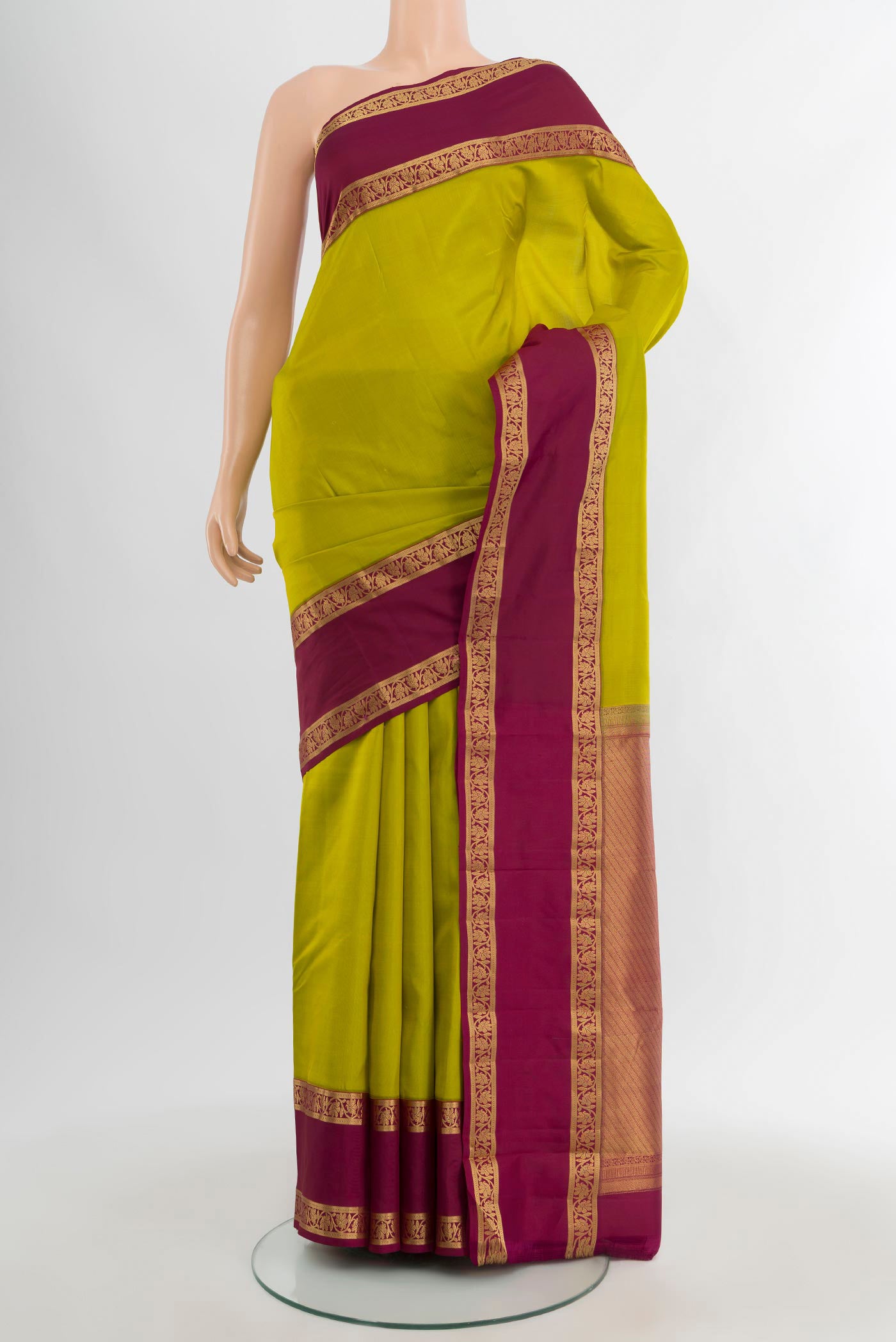 Parrot Green Kanchipuram Silk Saree with Plain Body and Zari Border.  displayed on a mannequin