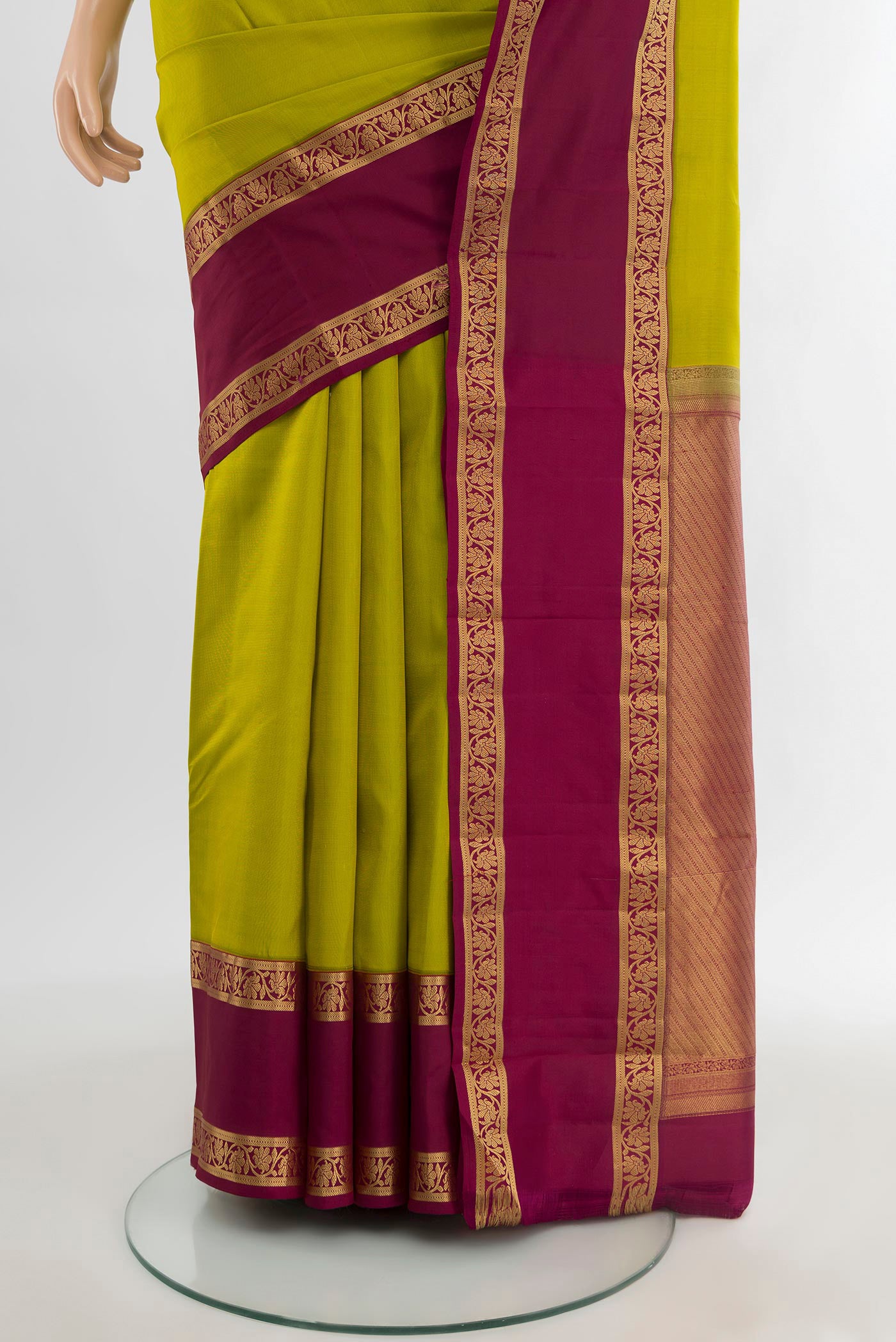 Pleats and pallu of Parrot Green Kanchipuram Silk Saree with Plain Body and Zari Border. 