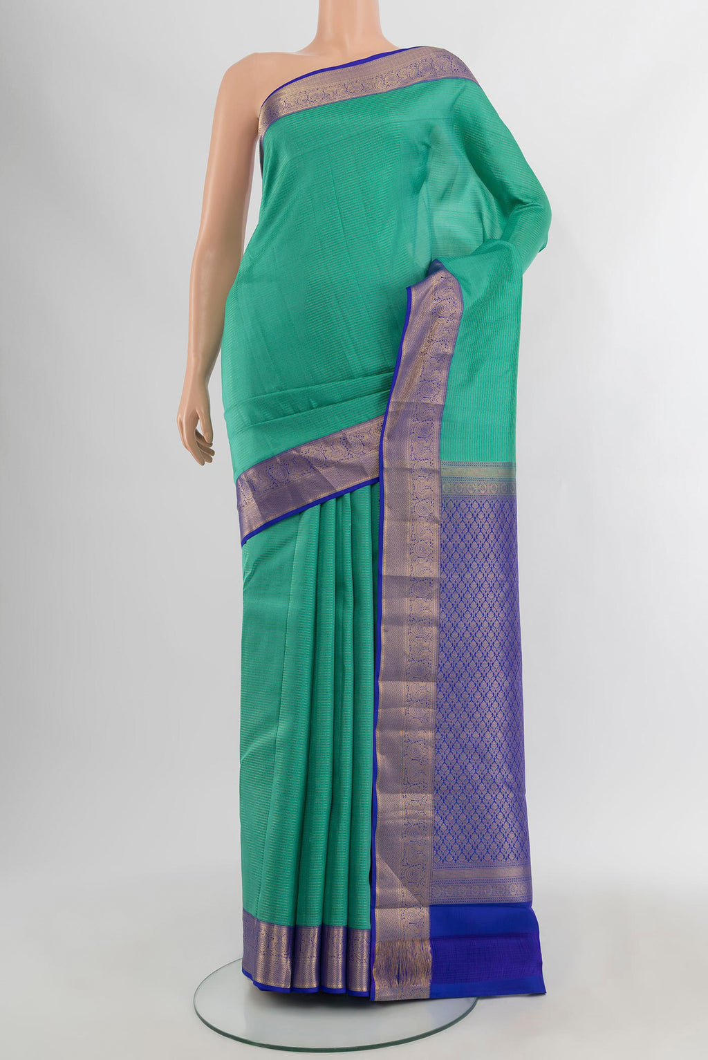 Turquoise Kanchipuram Silk Saree with Zari Butta on the body and Zari Border.  displayed on a mannequin
