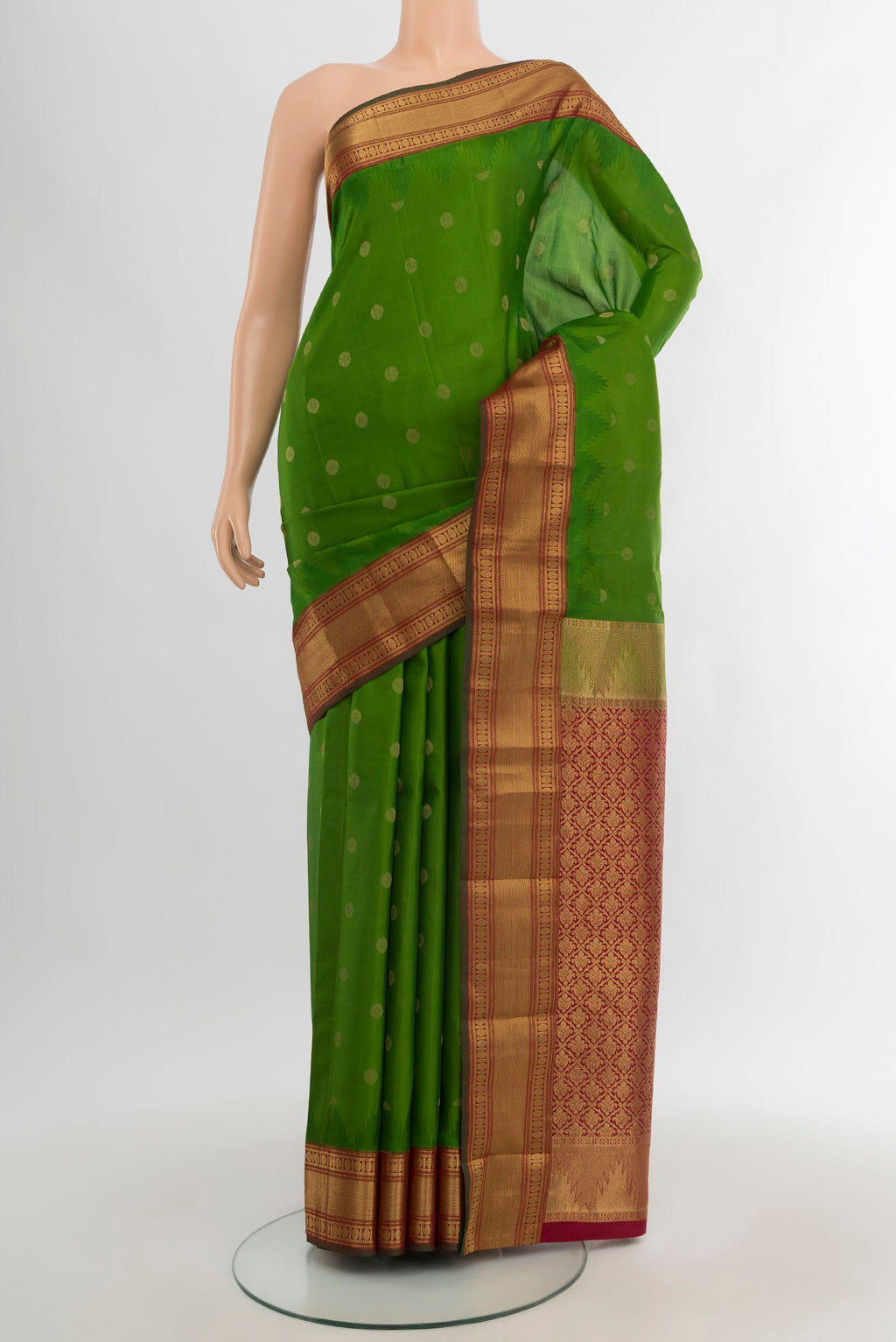 Green Kanchipuram Silk Saree with Zari Butta on the body and Zari Border.  displayed on a mannequin