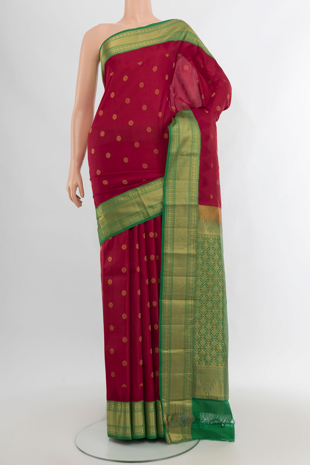 Maroon Kanchipuram Silk Saree with Zari Butta on the body and Zari Border.  displayed on a mannequin