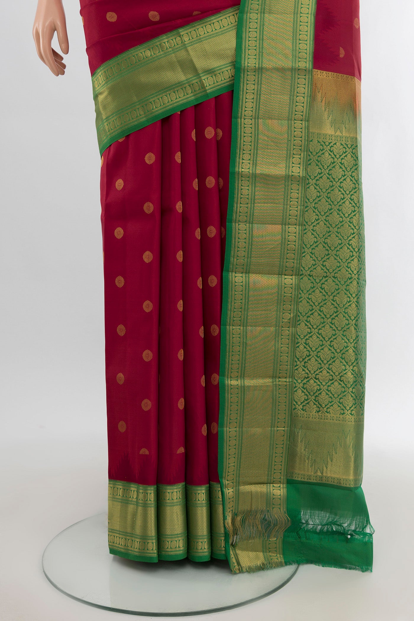 Pleats and pallu of Maroon Kanchipuram Silk Saree with Zari Butta on the body and Zari Border. 