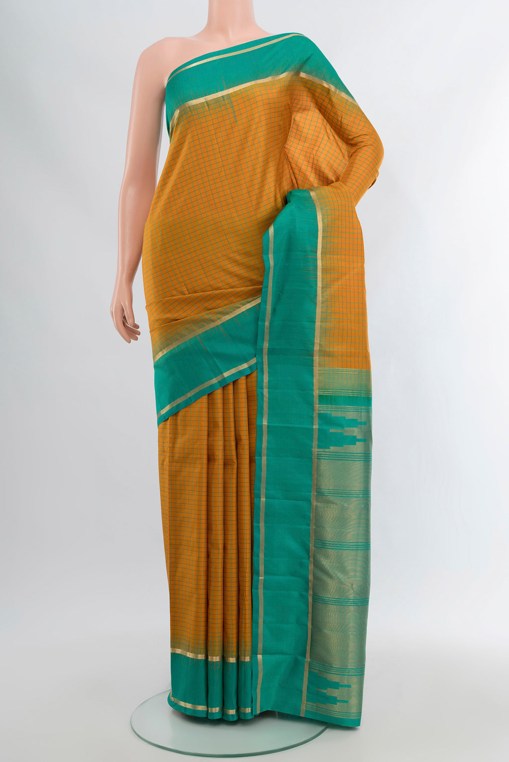 Mustard Kanchipuram Silk Saree with Checked design on the body and Zari Border.  displayed on a mannequin