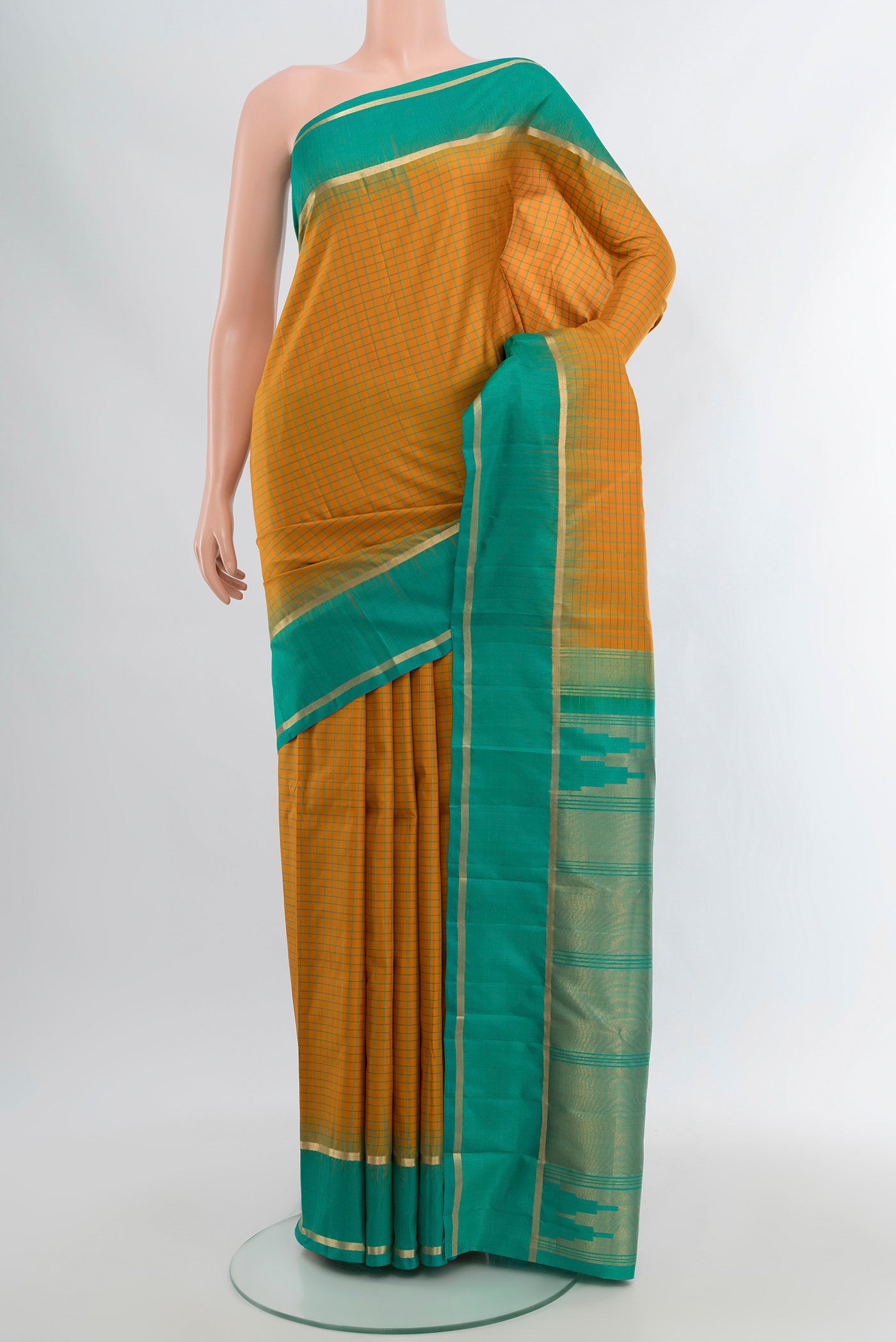 Mustard Kanchipuram Silk Saree with Checked design on the body and Zari Border.  displayed on a mannequin