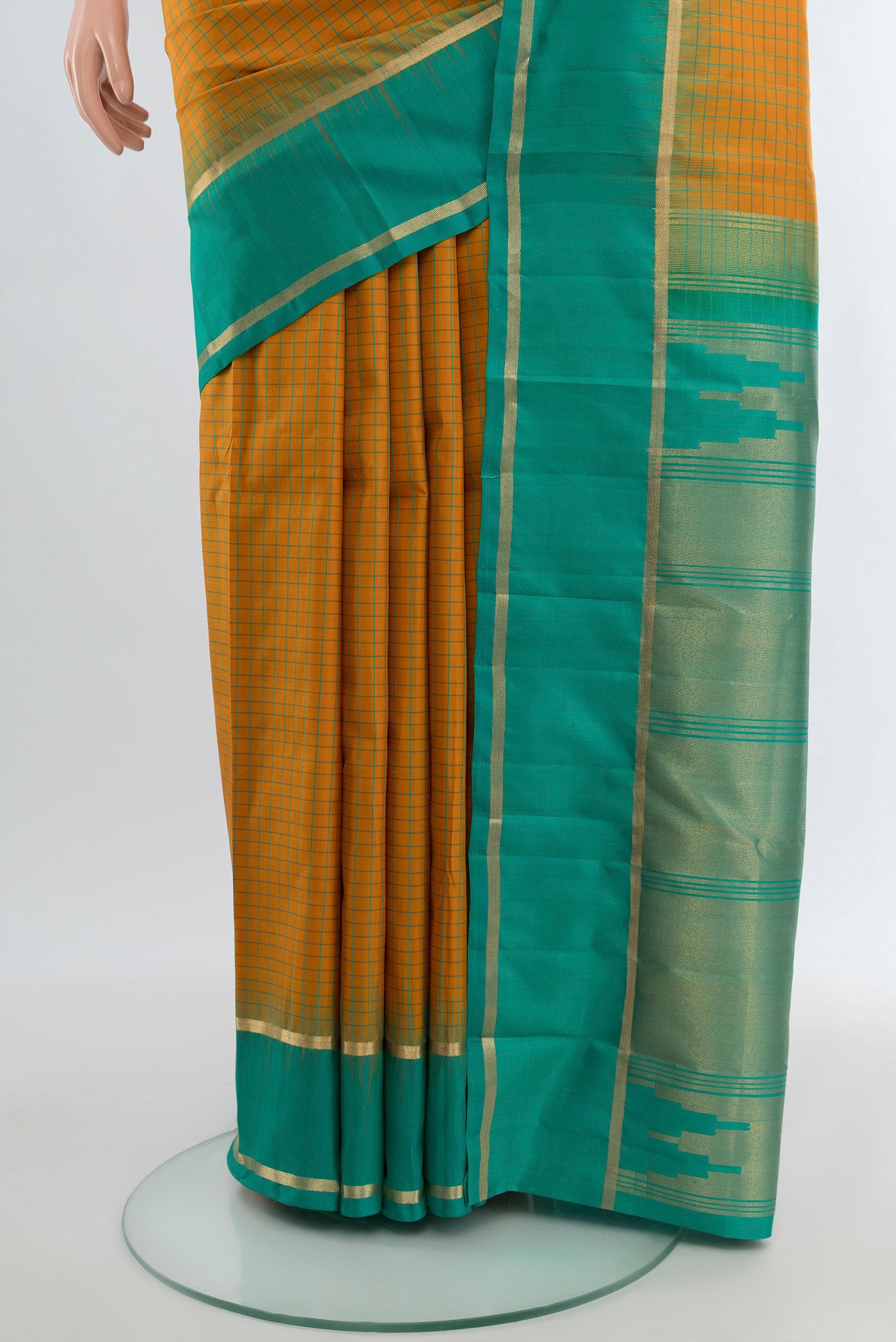 Pleats and pallu of Mustard Kanchipuram Silk Saree with Checked design on the body and Zari Border. 