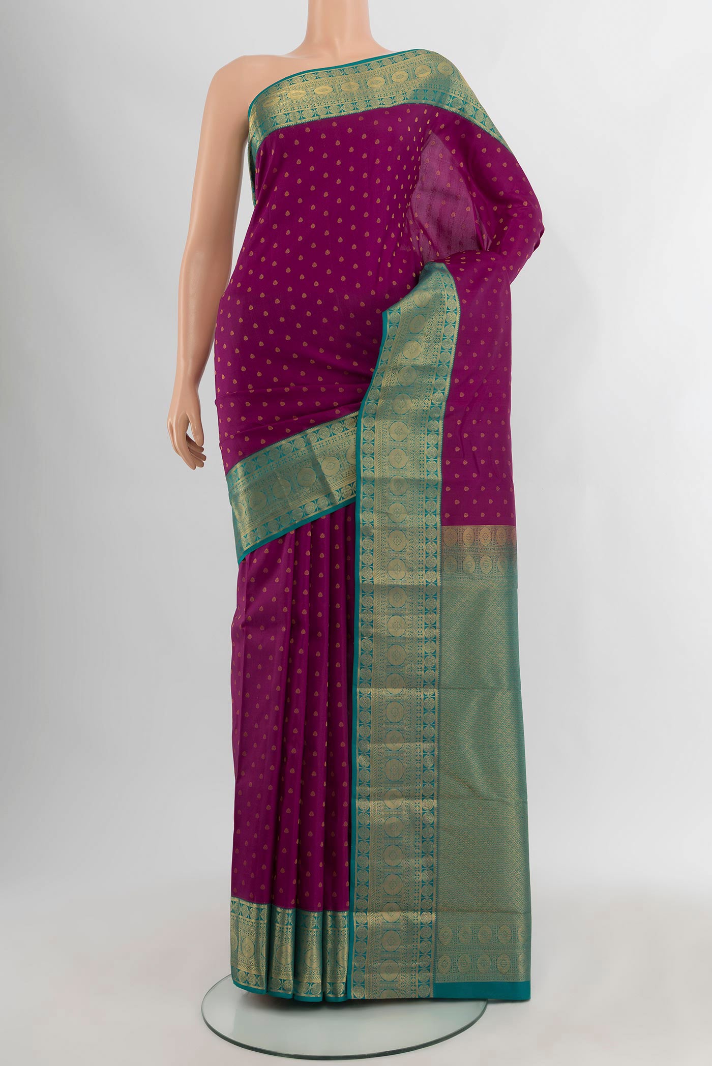 Purple Kanchipuram Silk Saree with Zari Butta on the body and Zari Border.  displayed on a mannequin