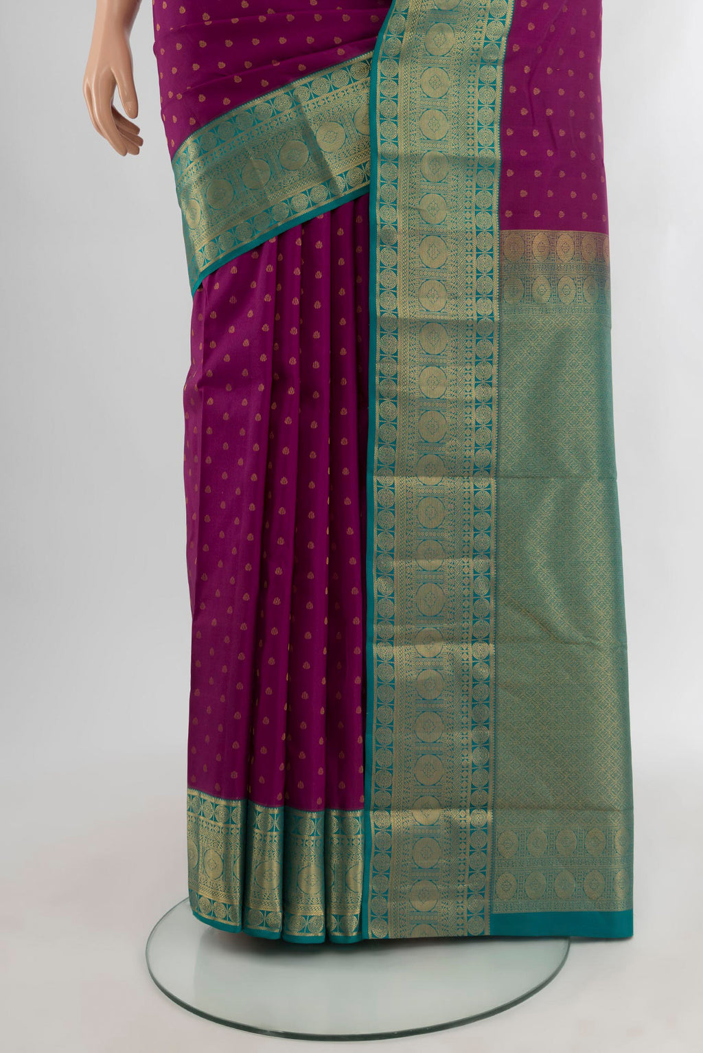 Pleats and pallu of Purple Kanchipuram Silk Saree with Zari Butta on the body and Zari Border. 