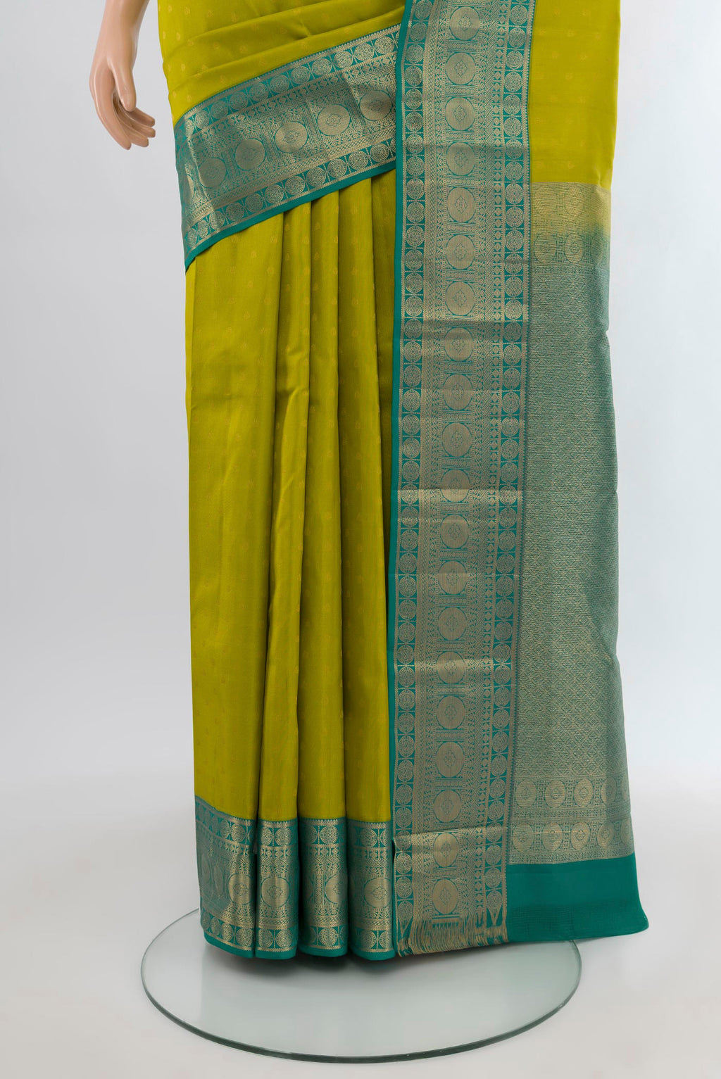 Pleats and pallu of Parrot Green Kanchipuram Silk Saree with Zari Butta on the body and Zari Border. 