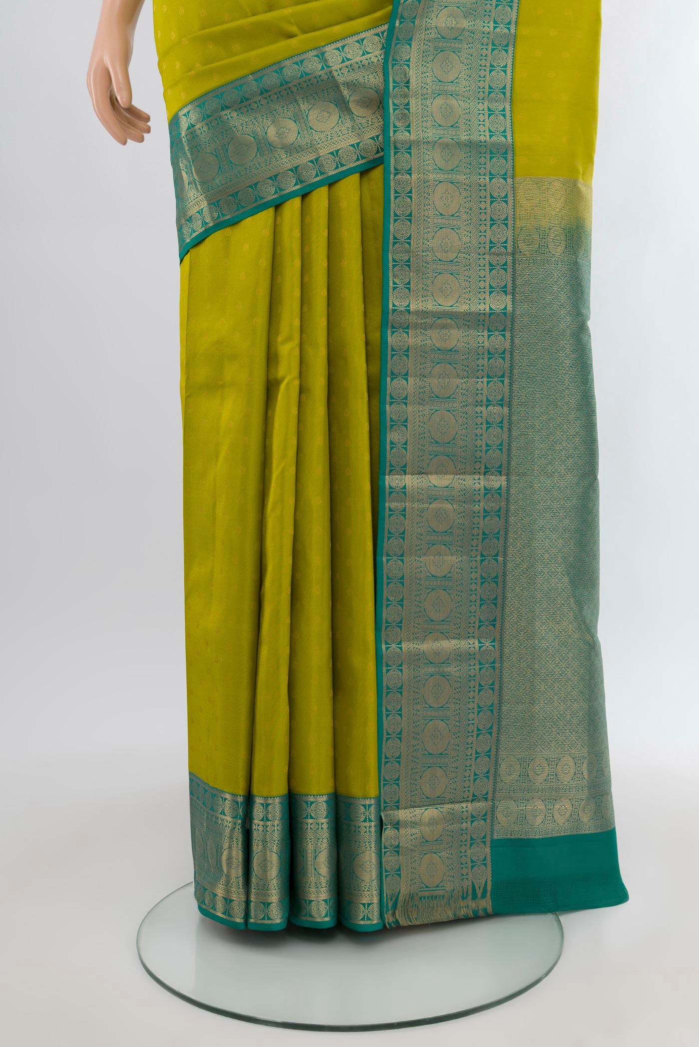 Pleats and pallu of Parrot Green Kanchipuram Silk Saree with Zari Butta on the body and Zari Border. 