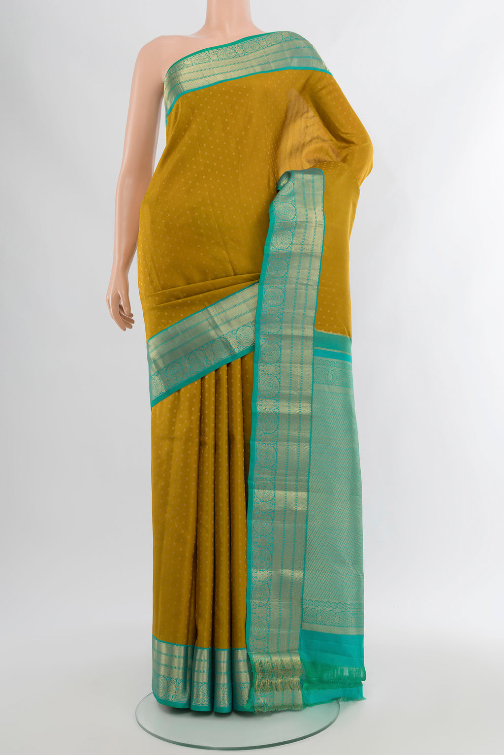 Mehandi Green Kanchipuram Silk Saree with Zari Butta on the body and Silk Border.  displayed on a mannequin