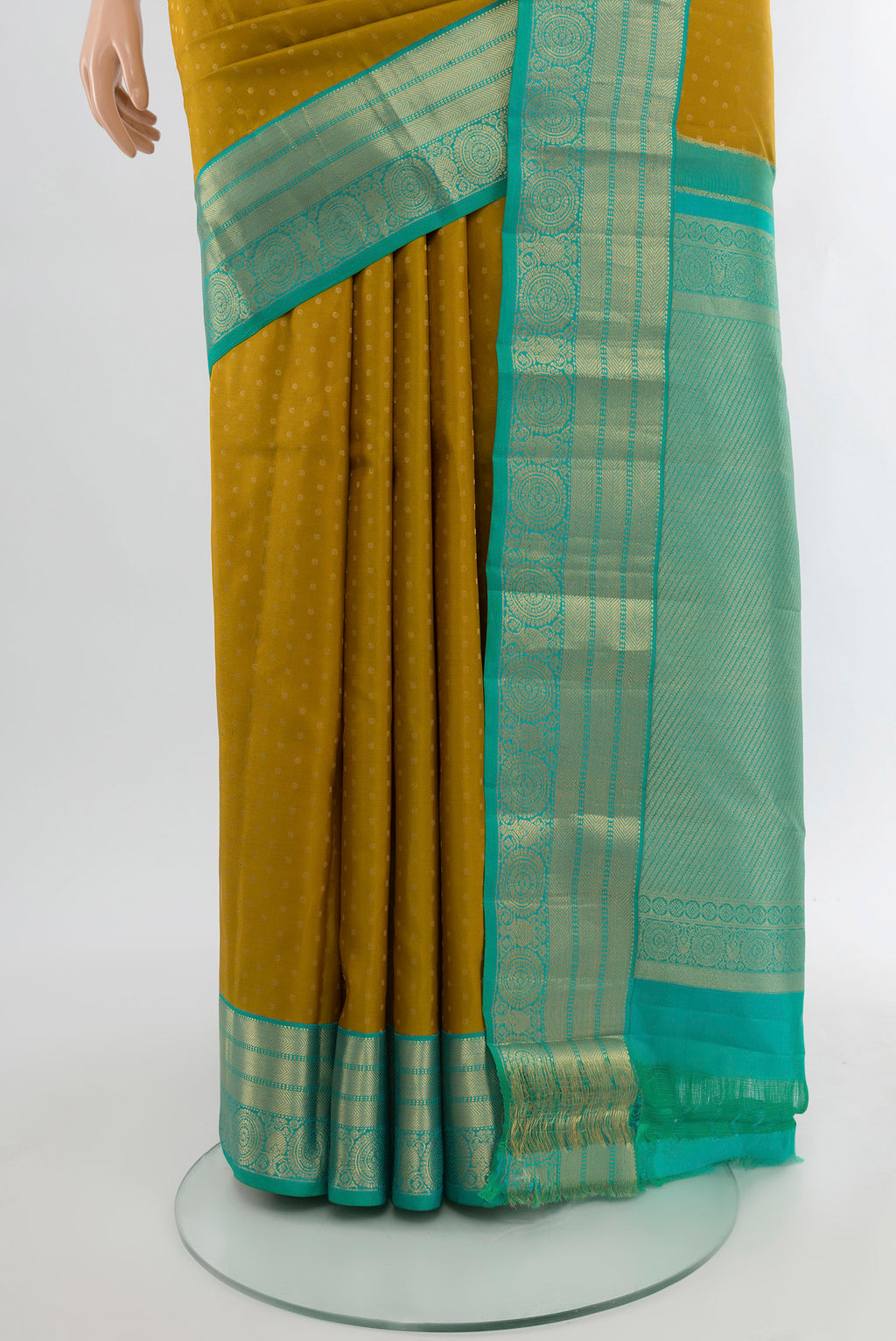 Pleats and pallu of Mehandi Green Kanchipuram Silk Saree with Zari Butta on the body and Silk Border. 