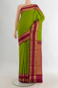 Pure Silk Parrot Green Kanchipuram Saree with Zari Butta on the body and Zari Border.  displayed on a mannequin