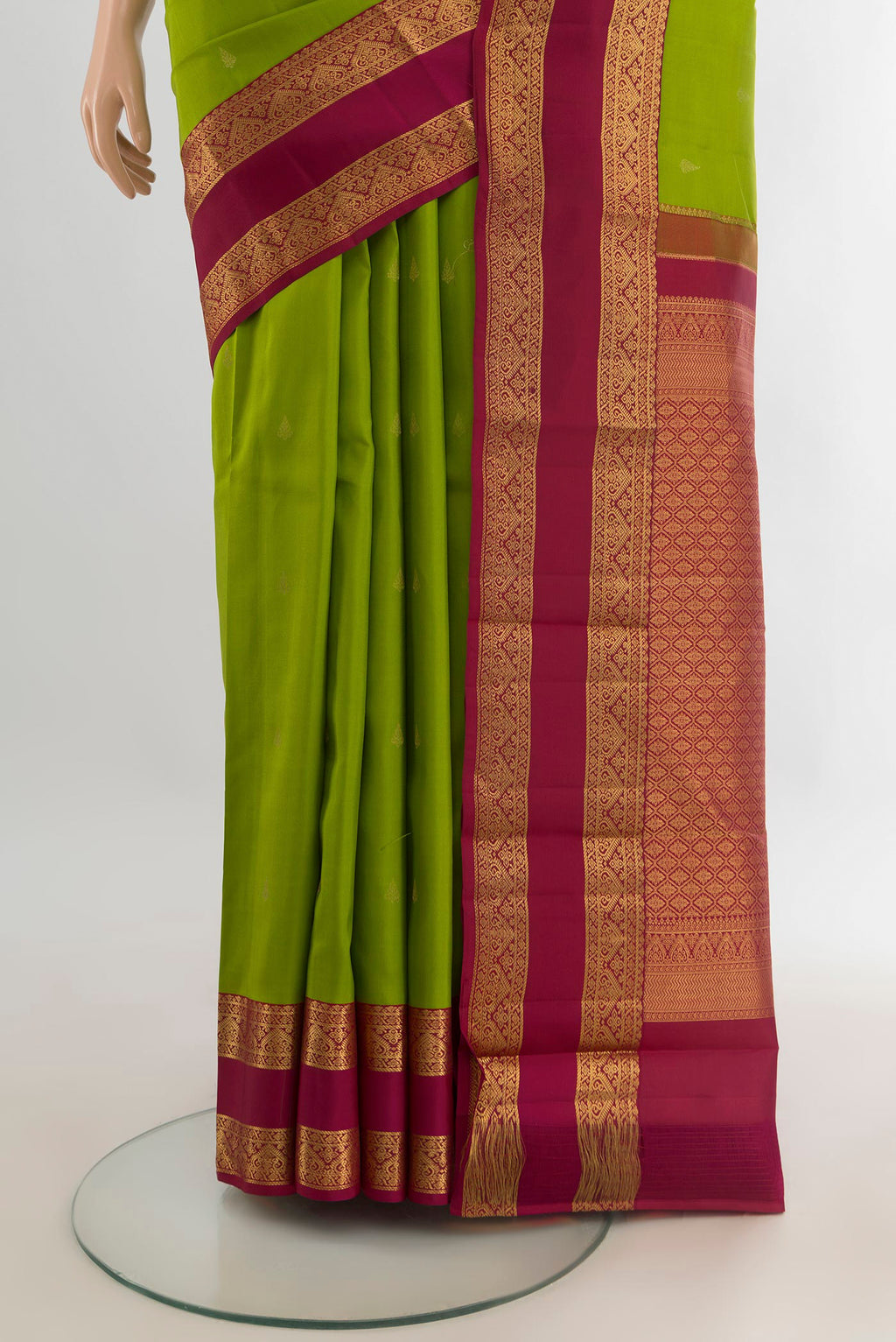 Pleats and pallu of Pure Silk Parrot Green Kanchipuram Saree with Zari Butta on the body and Zari Border. 