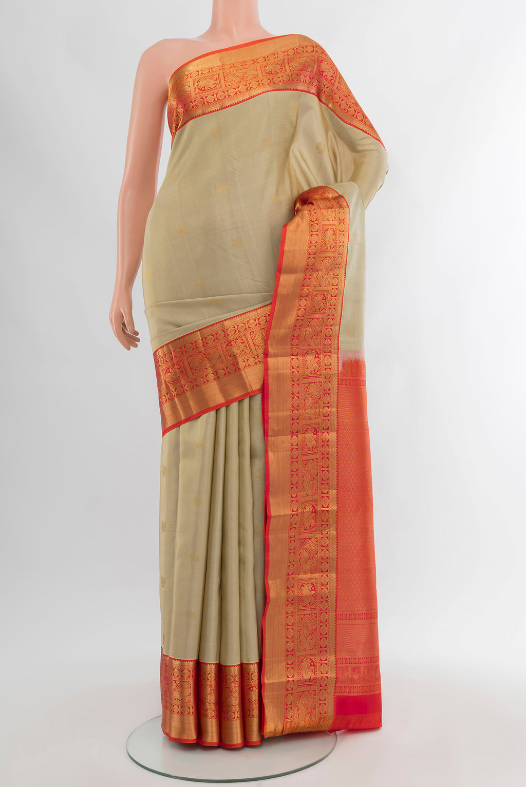 Beige Kanjivaram Silk Saree with Zari Butta on the body and Zari Border.  displayed on a mannequin