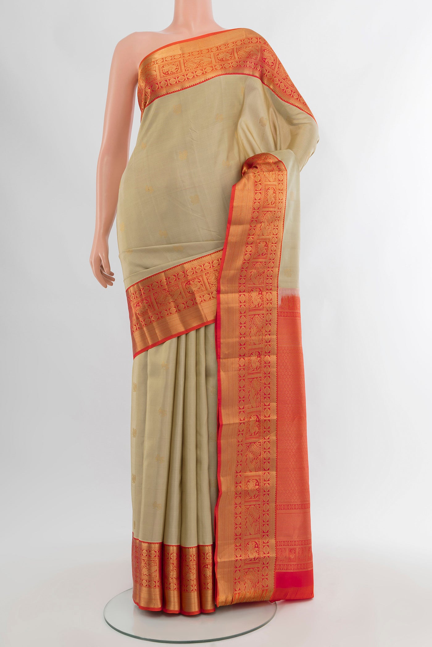 Beige Kanjivaram Silk Saree with Zari Butta on the body and Zari Border.  displayed on a mannequin
