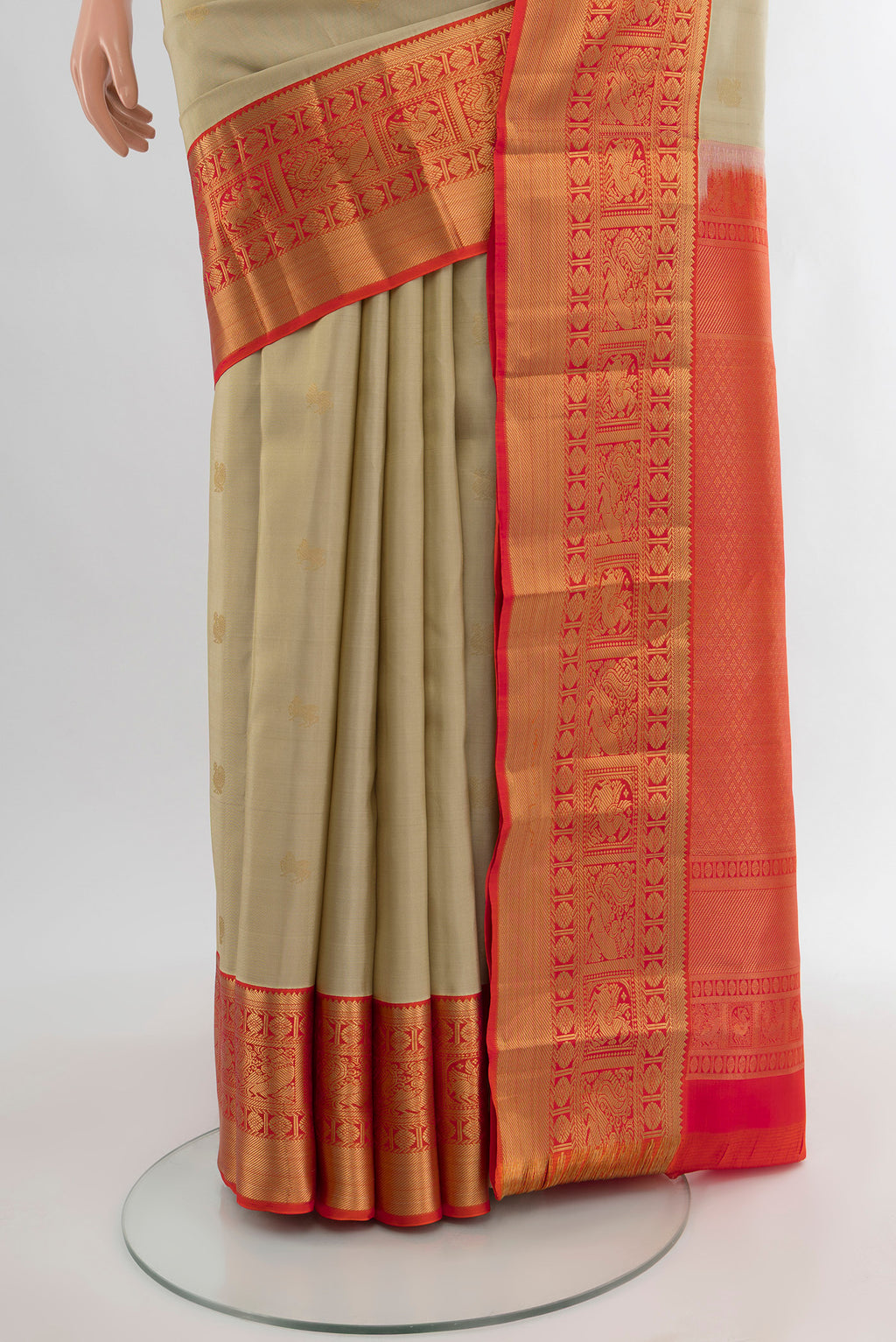 Pleats and pallu of Beige Kanjivaram Silk Saree with Zari Butta on the body and Zari Border. 