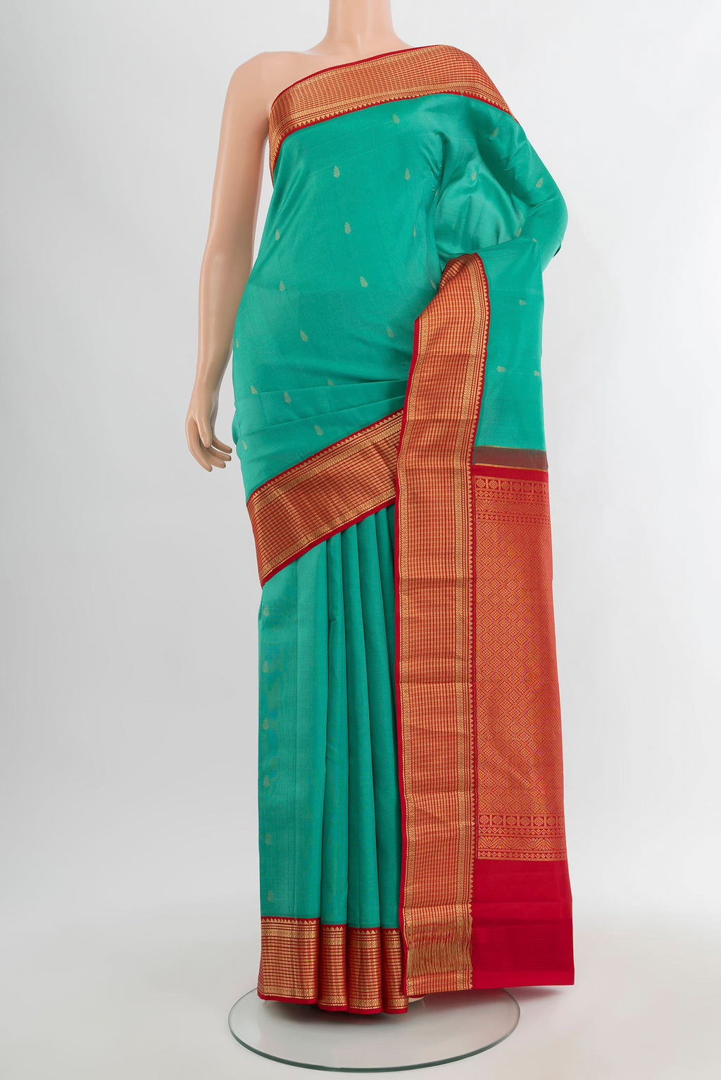 Turquoise Kanchipuram Silk Saree with Zari Butta on the body and Zari Border.  displayed on a mannequin