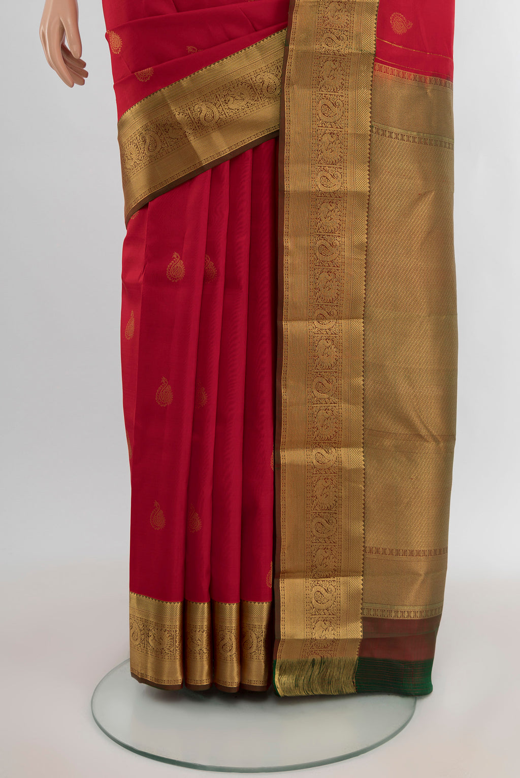 Pleats and pallu of Red Kanchipuram Silk Saree with Zari Butta on the body and Zari Border. 