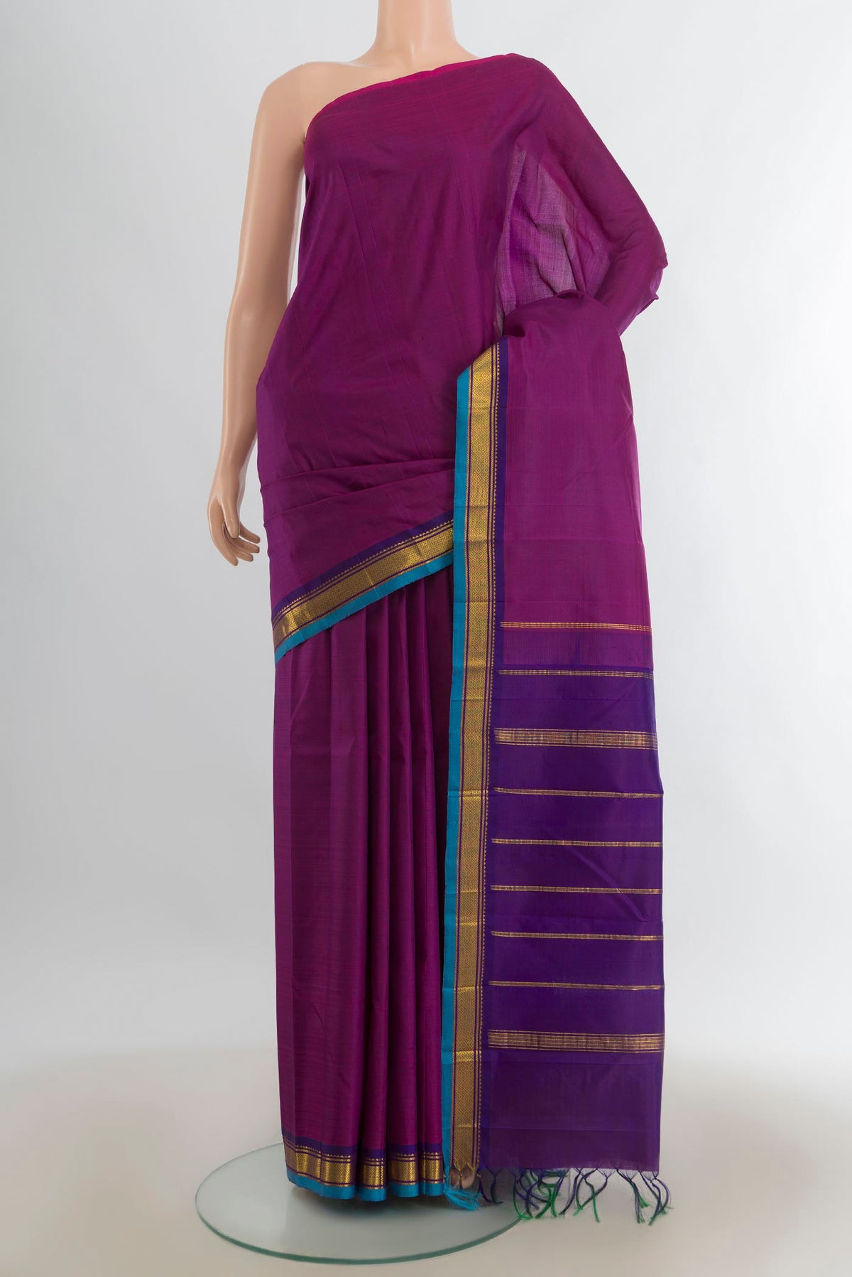 Pure Silk Purple Kanjivaram Saree with Zari Butta on the body and Silk Border.  displayed on a mannequin