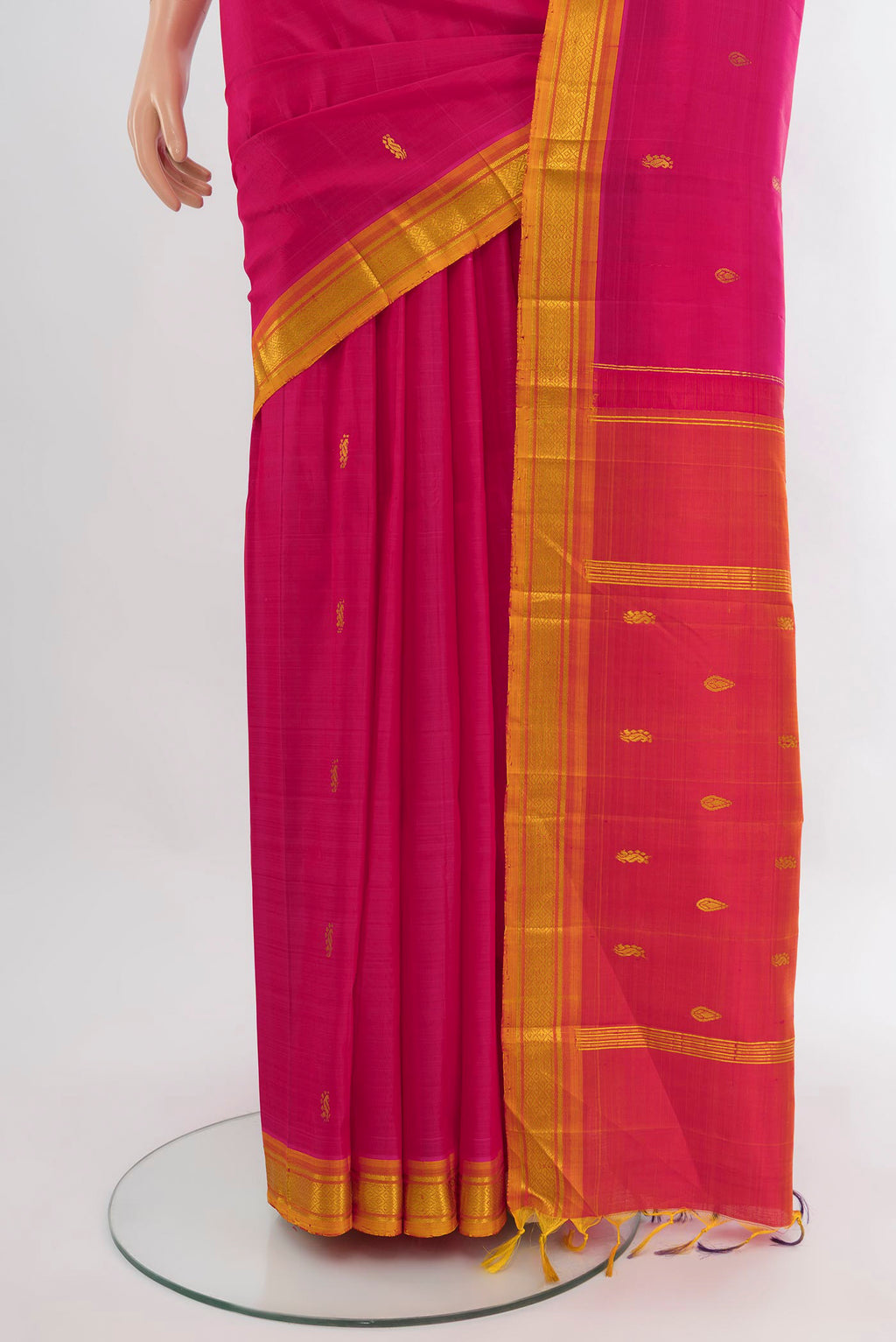 Pleats and pallu of Pink Kanjivaram Silk Saree with Zari Butta on the body and One Side Border. 
