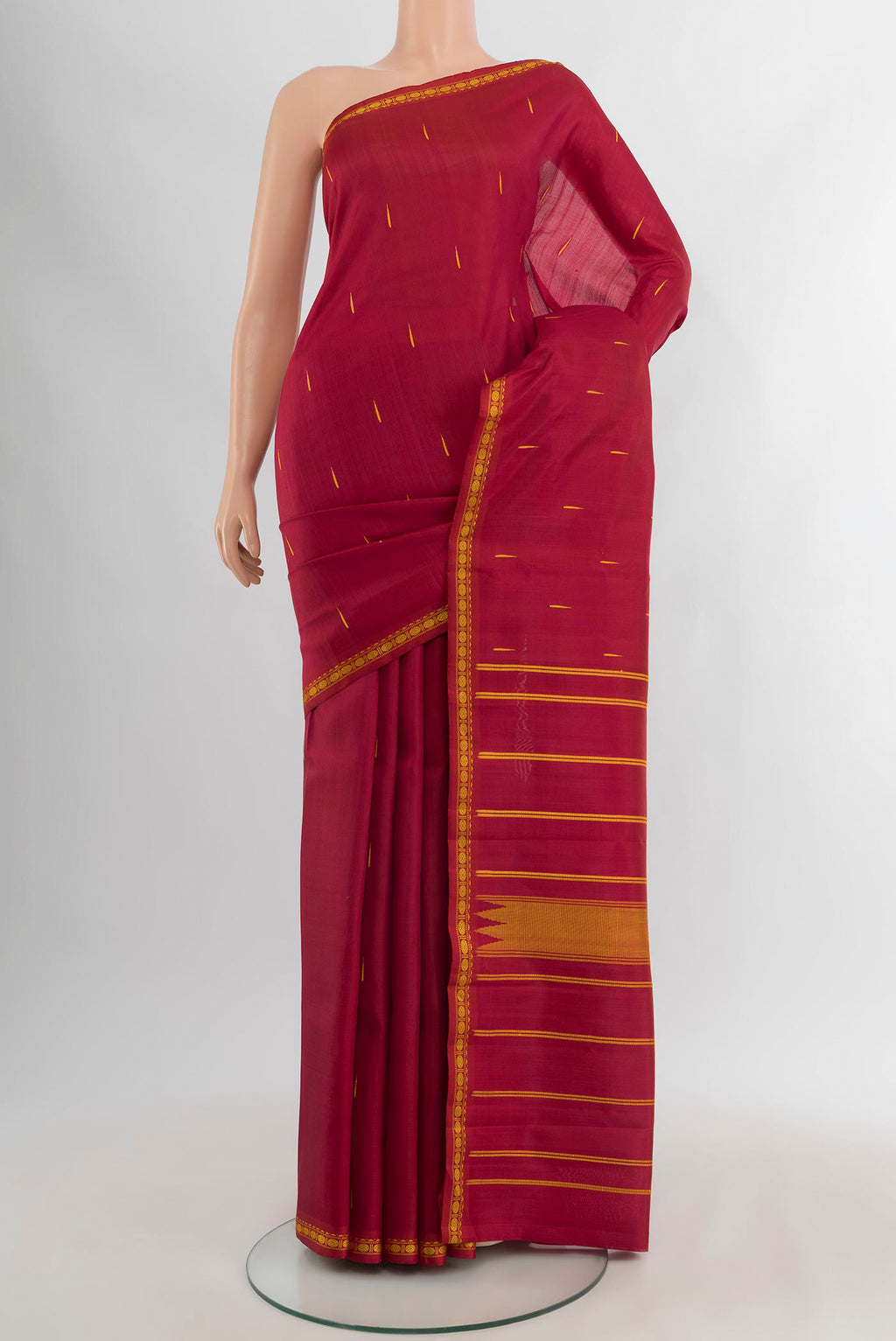 Maroon Kanchipuram Silk Saree with Thread Butta on the body and Thread Border.  displayed on a mannequin