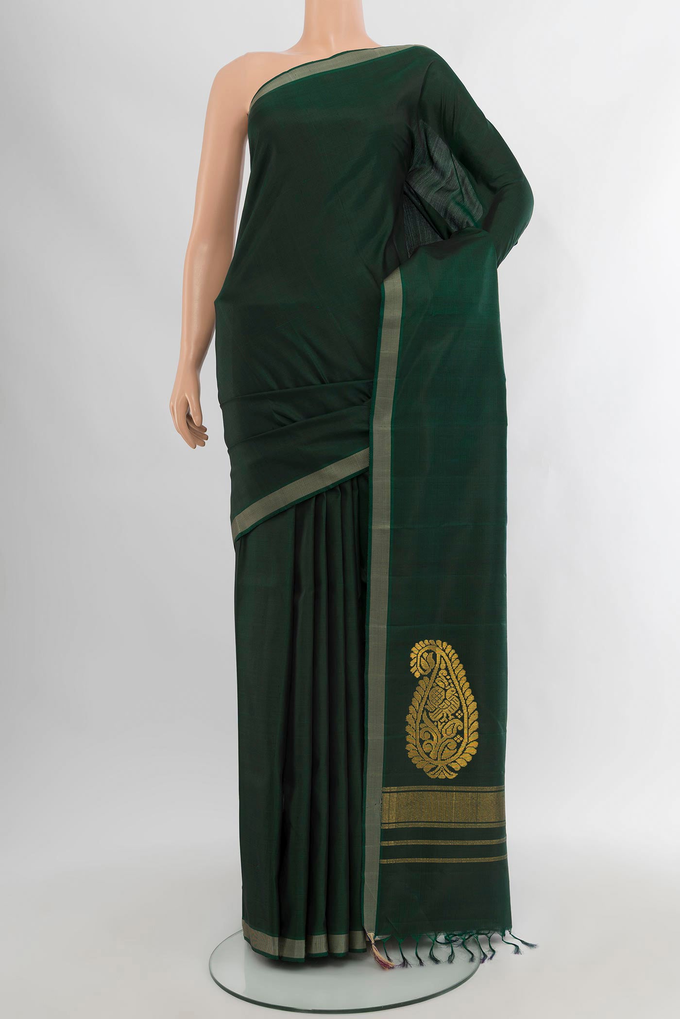 Bottle Green Kanchipuram Silk Saree with Plain Body and Thread Border.  displayed on a mannequin