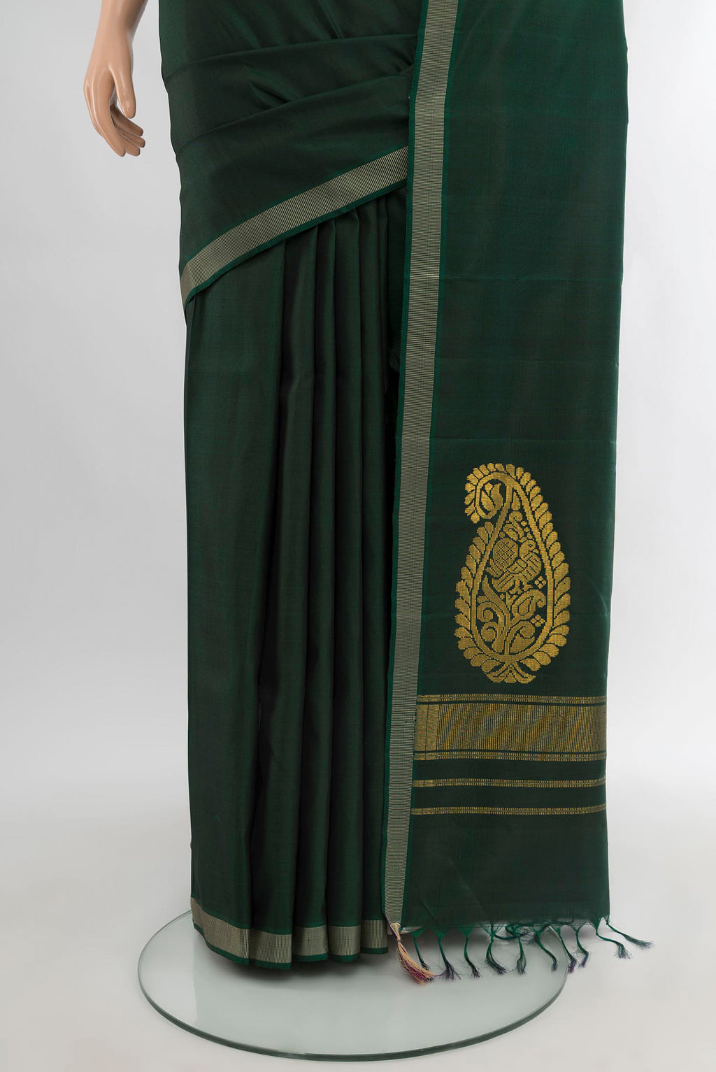 Pleats and pallu of Bottle Green Kanchipuram Silk Saree with Plain Body and Thread Border. 