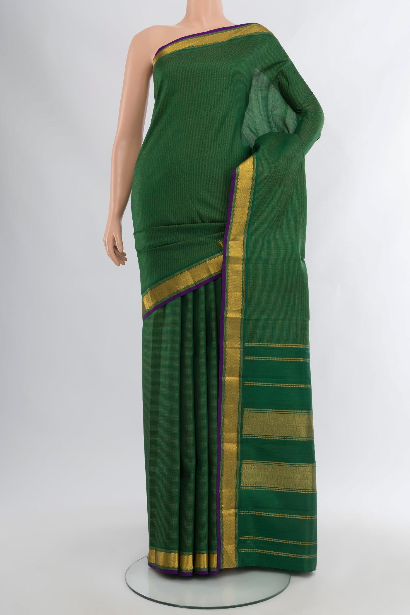 Bottle Green Kanchipuram Silk Saree with Plain Body and Zari Border.  displayed on a mannequin