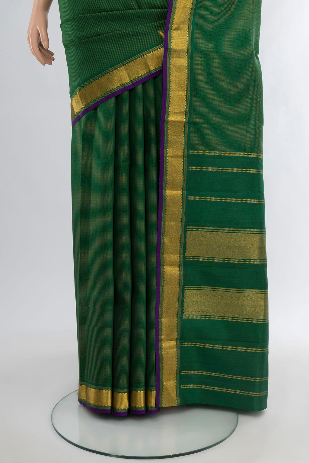 Pleats and pallu of Bottle Green Kanchipuram Silk Saree with Plain Body and Zari Border. 