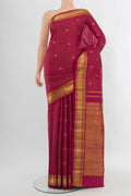 Maroon Kanchipuram Silk Saree with Checked design on the body and Zari Border.  displayed on a mannequin