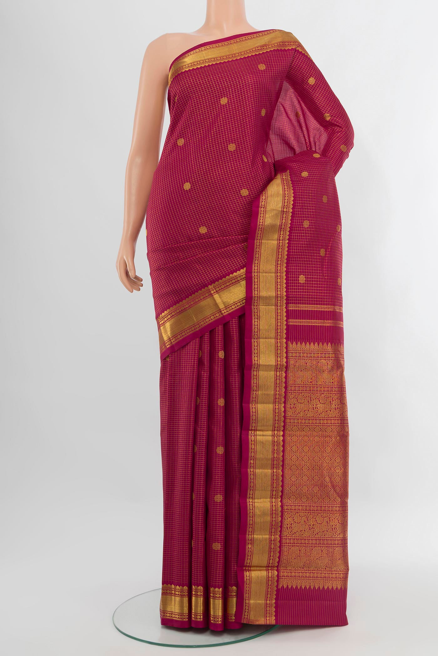 Maroon Kanchipuram Silk Saree with Checked design on the body and Zari Border.  displayed on a mannequin