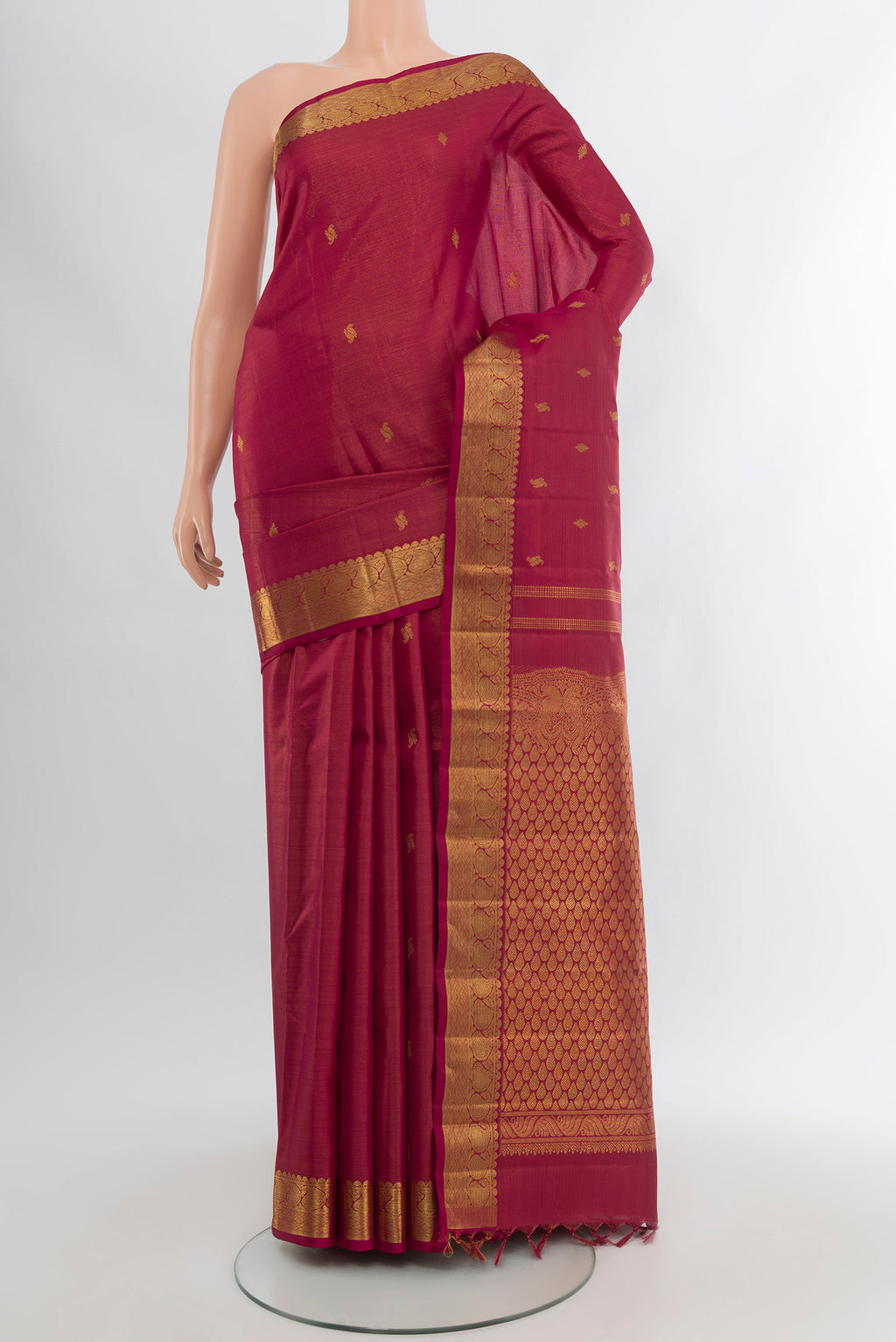 Pure Silk Pure Zari Maroon Kanchipuram Saree with Zari Butta on the body and Silk Border.  displayed on a mannequin