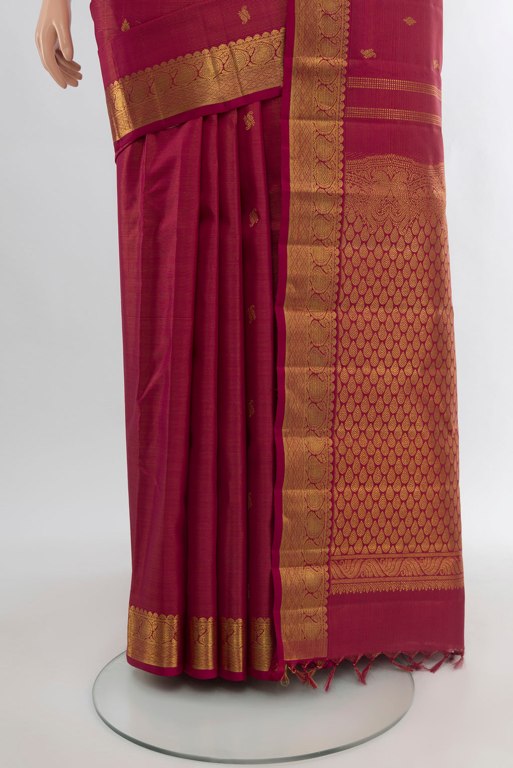 Pleats and pallu of Pure Silk Pure Zari Maroon Kanchipuram Saree with Zari Butta on the body and Silk Border. 