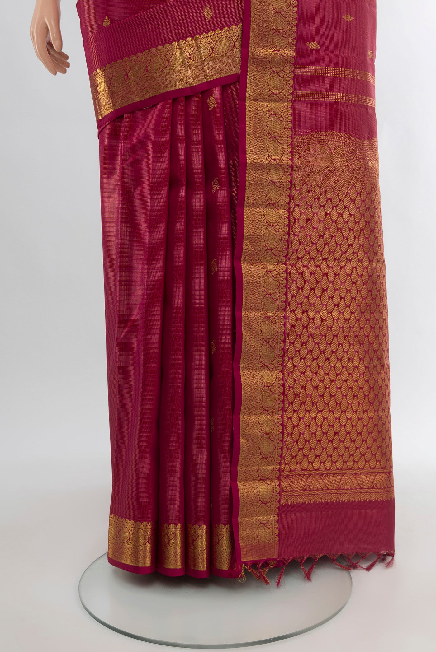 Pleats and pallu of Pure Silk Pure Zari Maroon Kanchipuram Saree with Zari Butta on the body and Silk Border. 