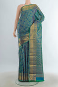 Pure Silk Pure Zari Multi Color Kanchipuram Saree with Zari Butta on the body and Silk Border.  displayed on a mannequin