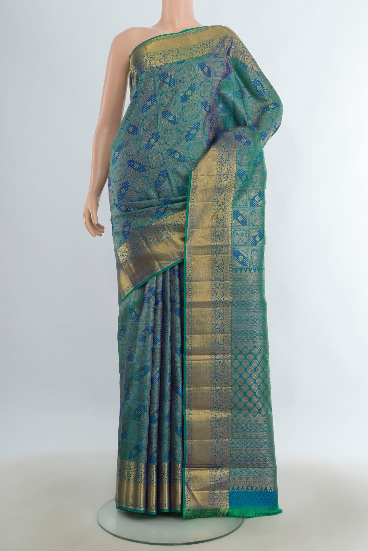Pure Silk Pure Zari Multi Color Kanchipuram Saree with Zari Butta on the body and Silk Border.  displayed on a mannequin
