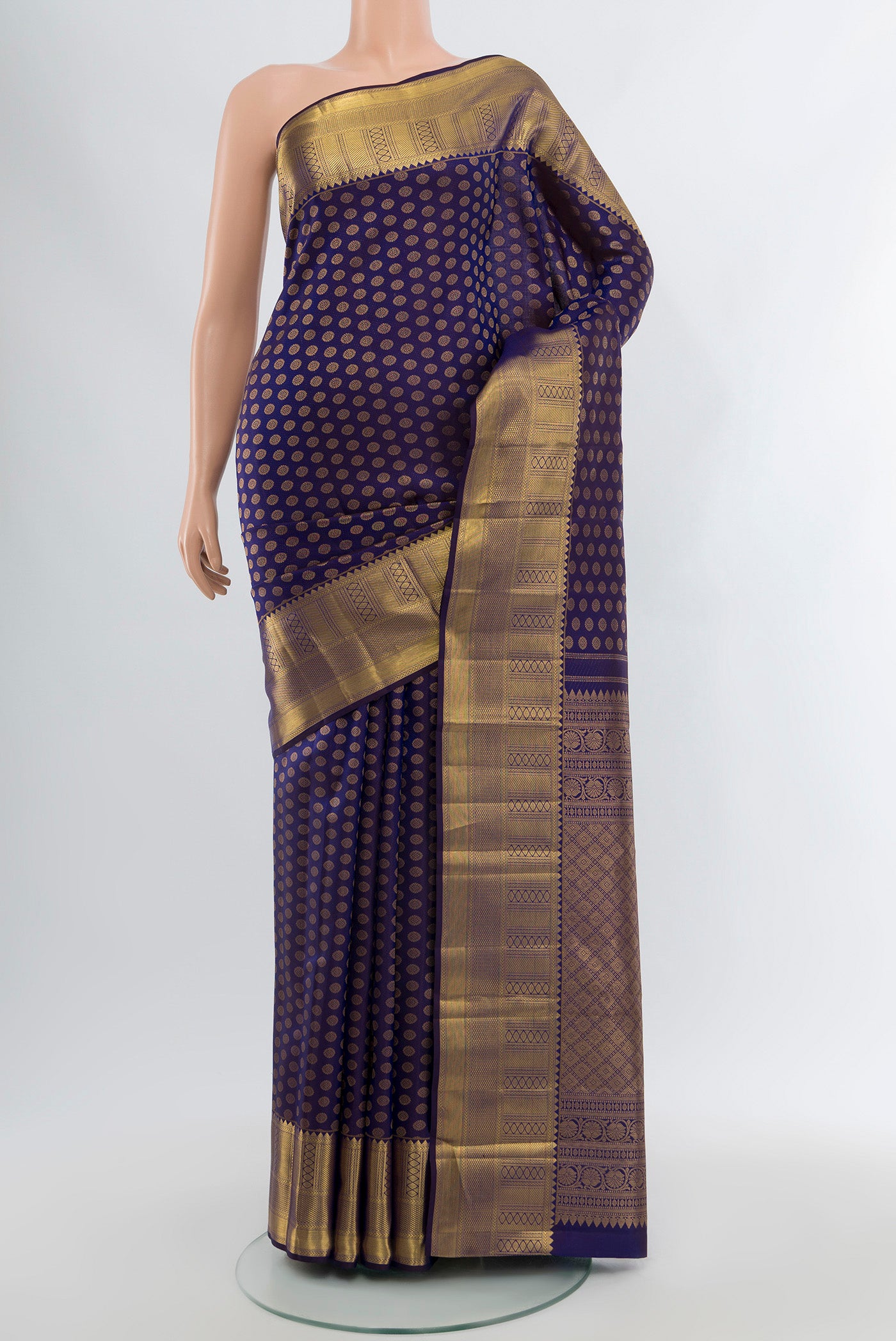 Navy Blue Kanchipuram Silk Saree with Zari Butta on the body and Zari Border.  displayed on a mannequin