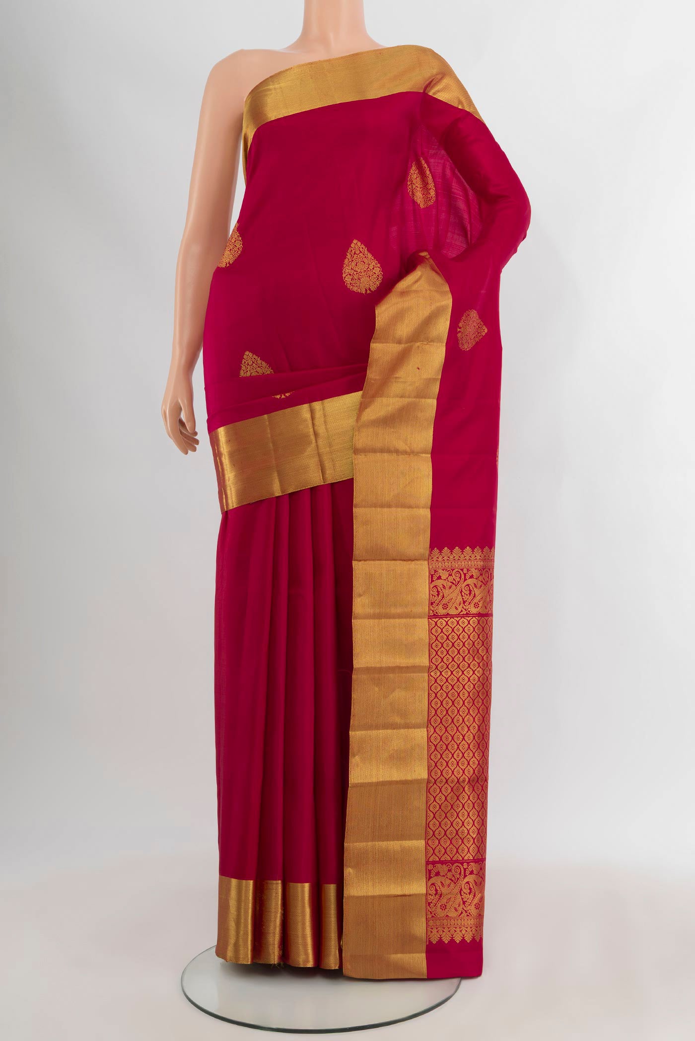 Dark Pink Kanchipuram Silk Saree with Zari Butta on the body and Zari Border.  displayed on a mannequin
