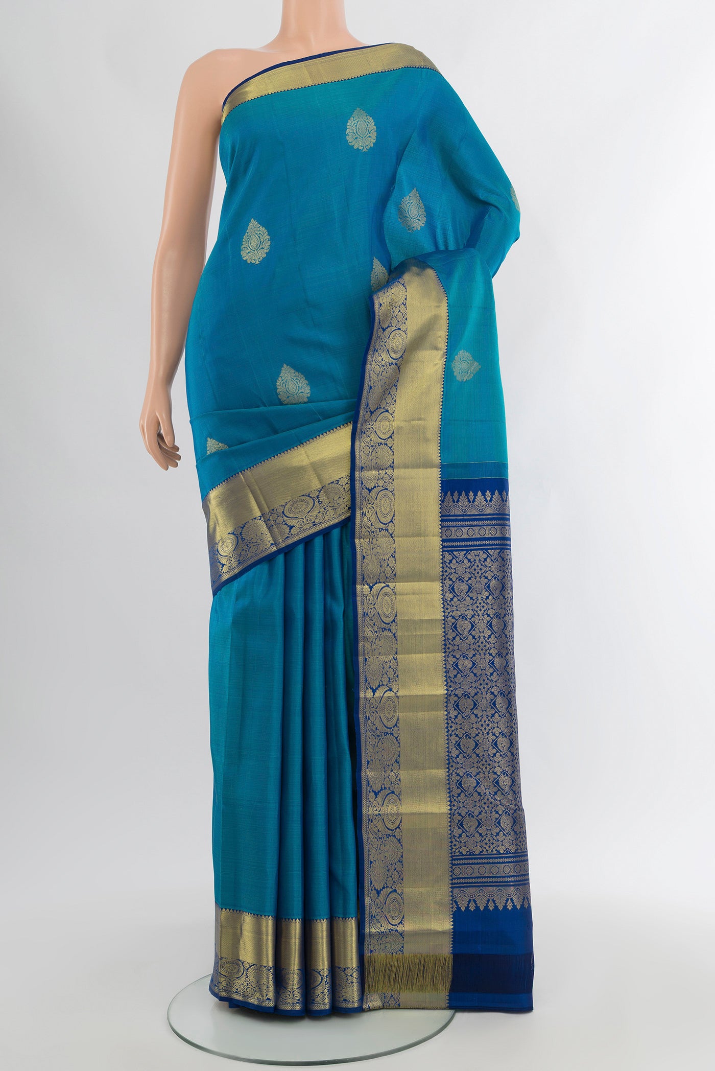 Blue Kanchipuram Silk Saree with Zari Butta on the body and Zari Border.  displayed on a mannequin