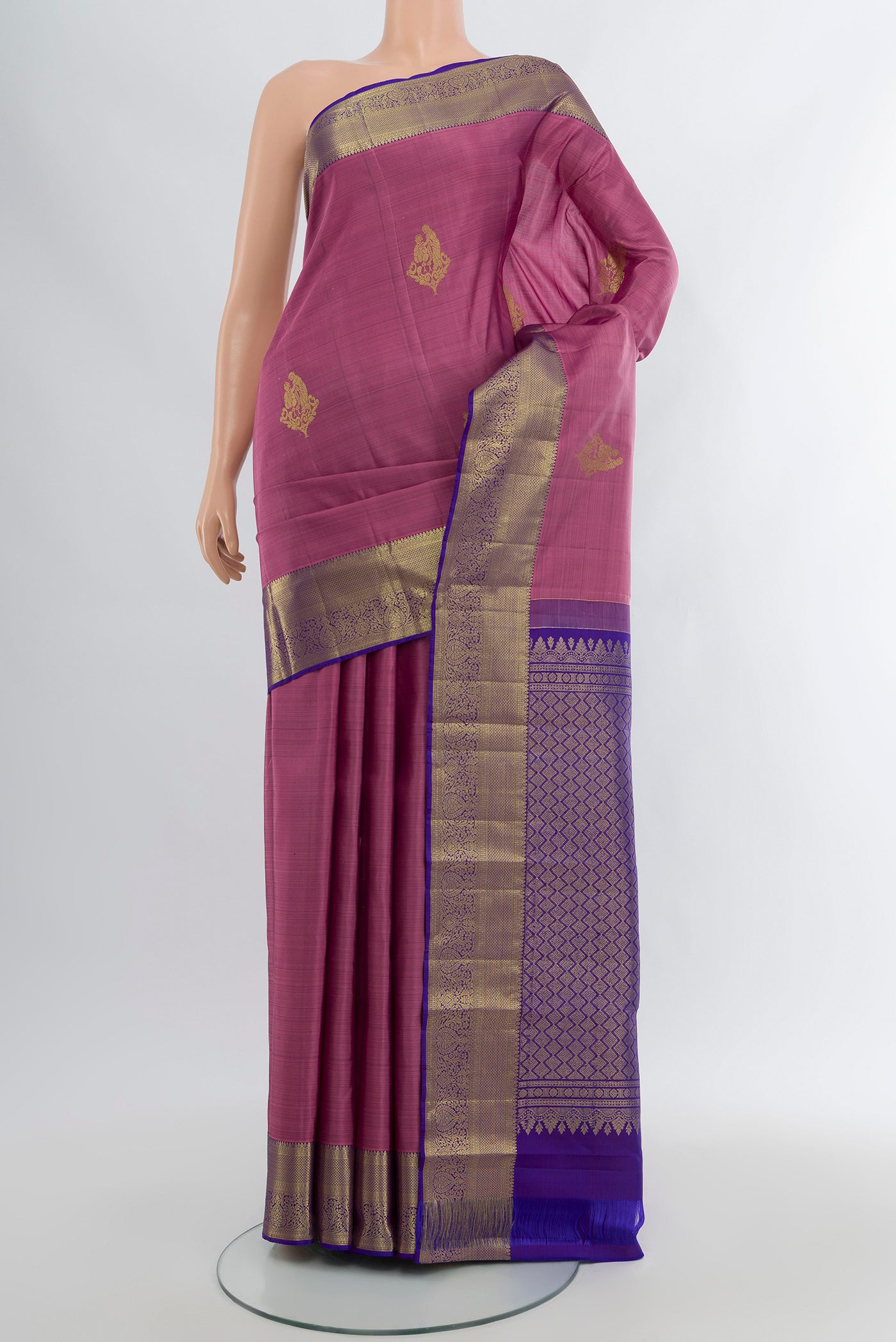 Mauve Kanchipuram Silk Saree with Zari Butta on the body and Zari Border.  displayed on a mannequin