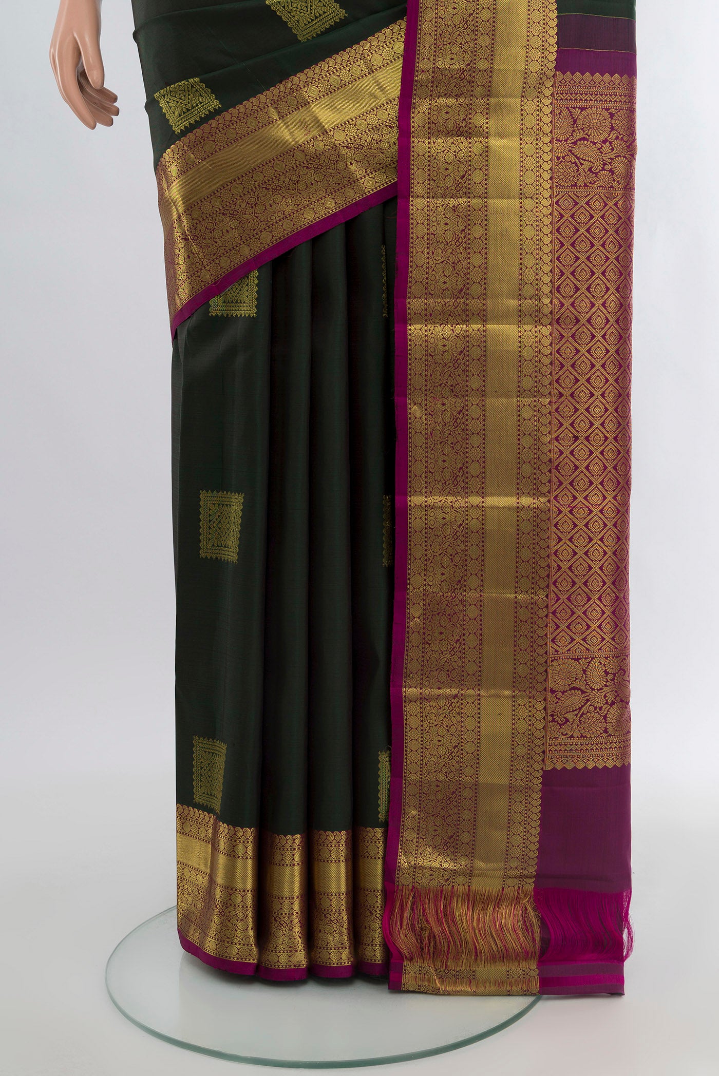 Pleats and pallu of Bottle Green Kanchipuram Silk Saree with Zari Butta on the body and Zari Border. 