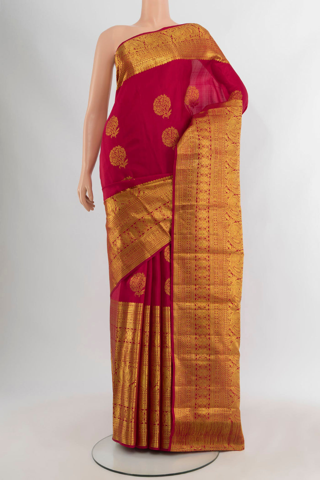 Maroon Kanjivaram Silk Saree with Zari Butta on the body and Zari Border.  displayed on a mannequin