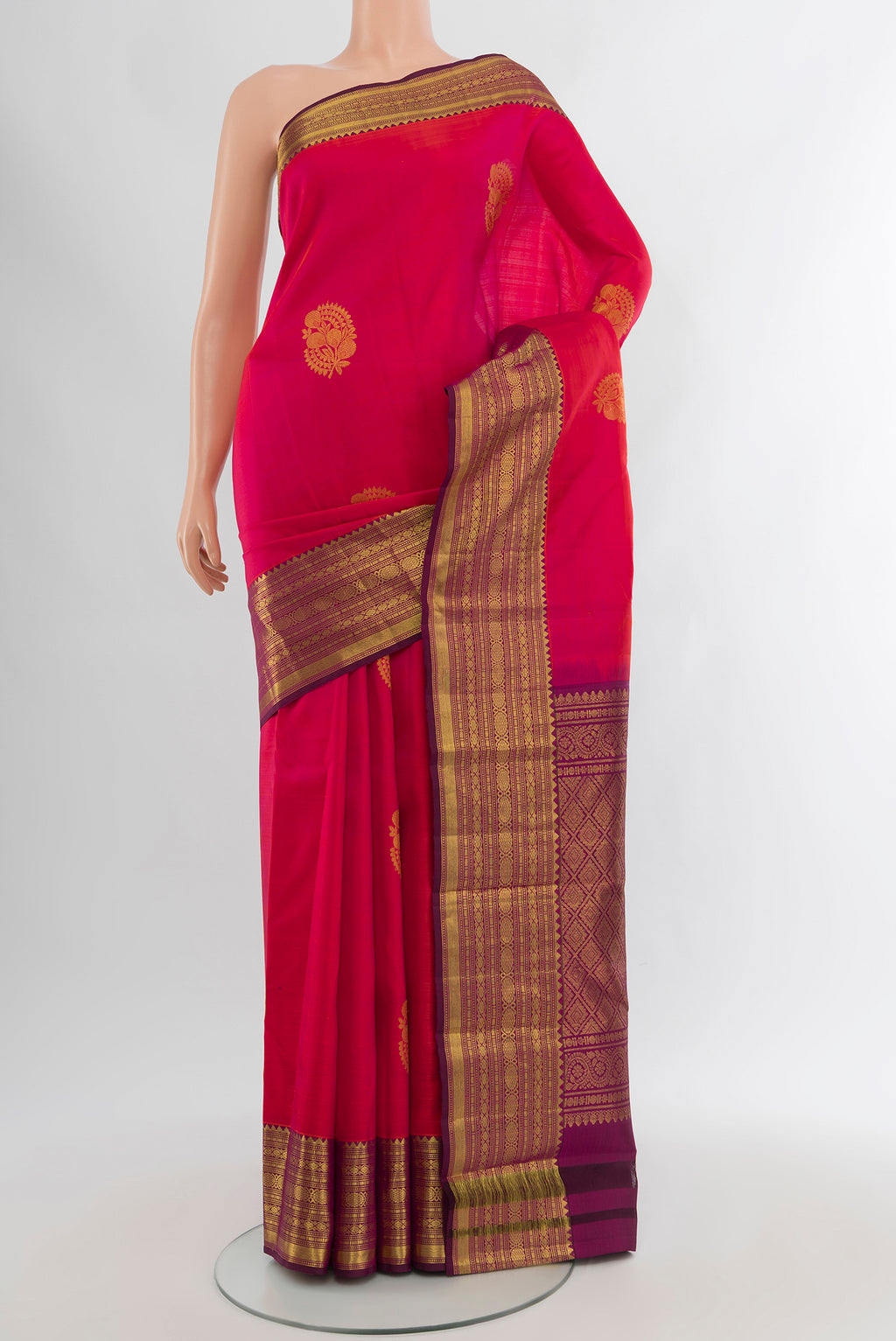 Pink Kanchipuram Silk Saree with Zari Butta on the body and Zari Border.  displayed on a mannequin