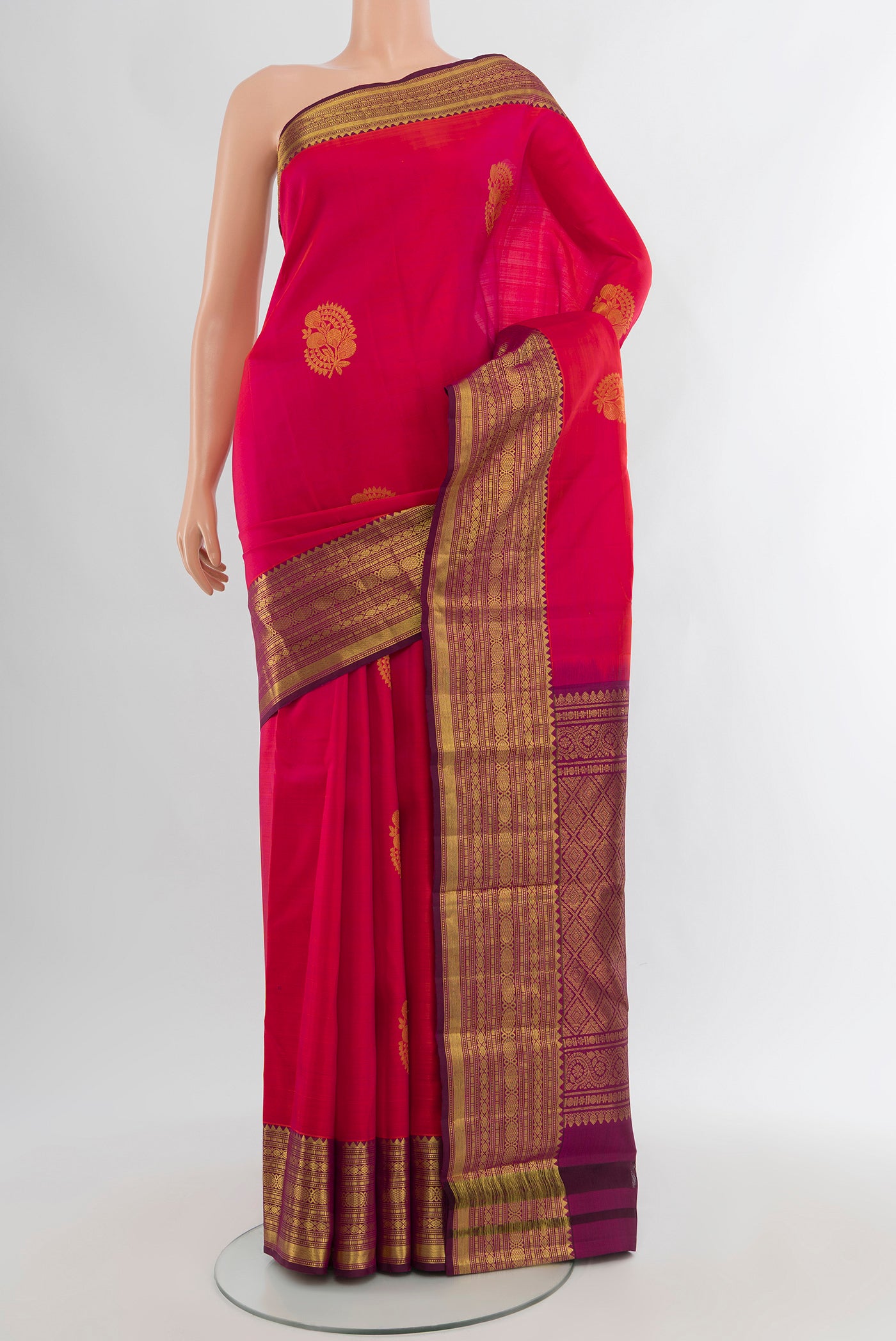 Pink Kanchipuram Silk Saree with Zari Butta on the body and Zari Border.  displayed on a mannequin