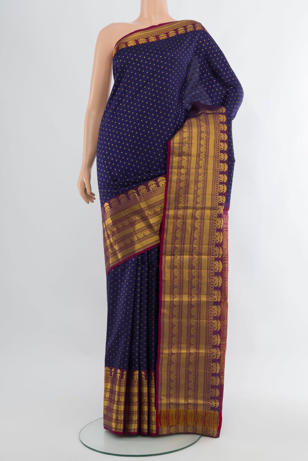 Navy Blue Kanchipuram Silk Saree with Zari Butta on the body and Zari Border.  displayed on a mannequin