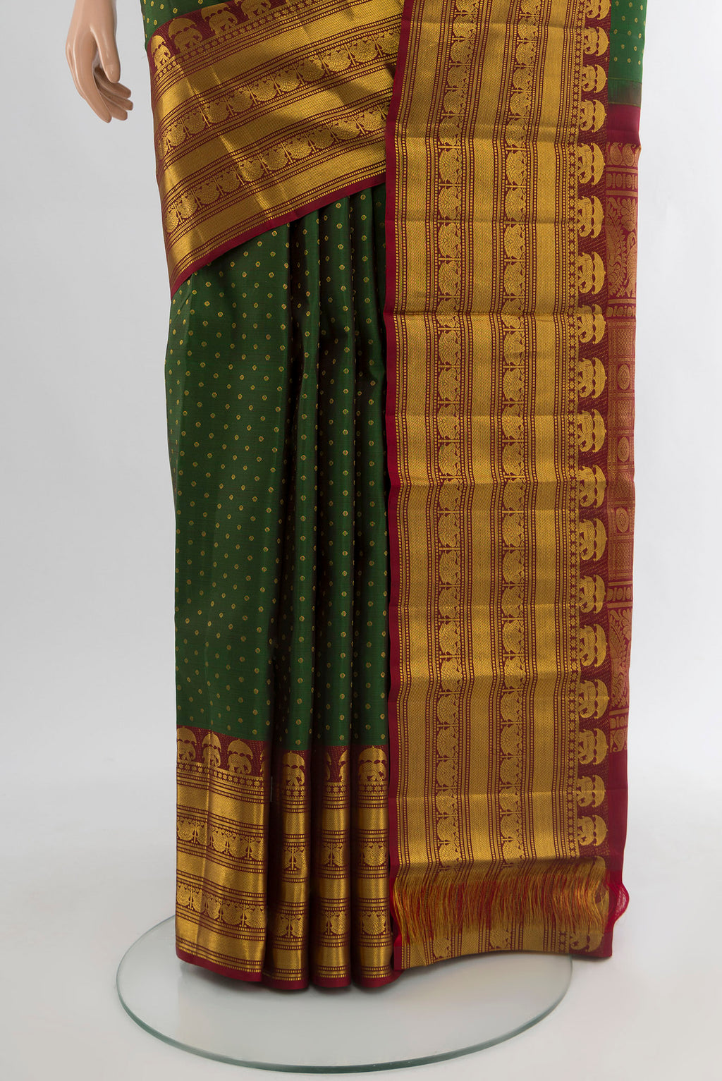 Pleats and pallu of Bottle Green Kanchipuram Silk Saree with Zari Butta on the body and Zari Border. 