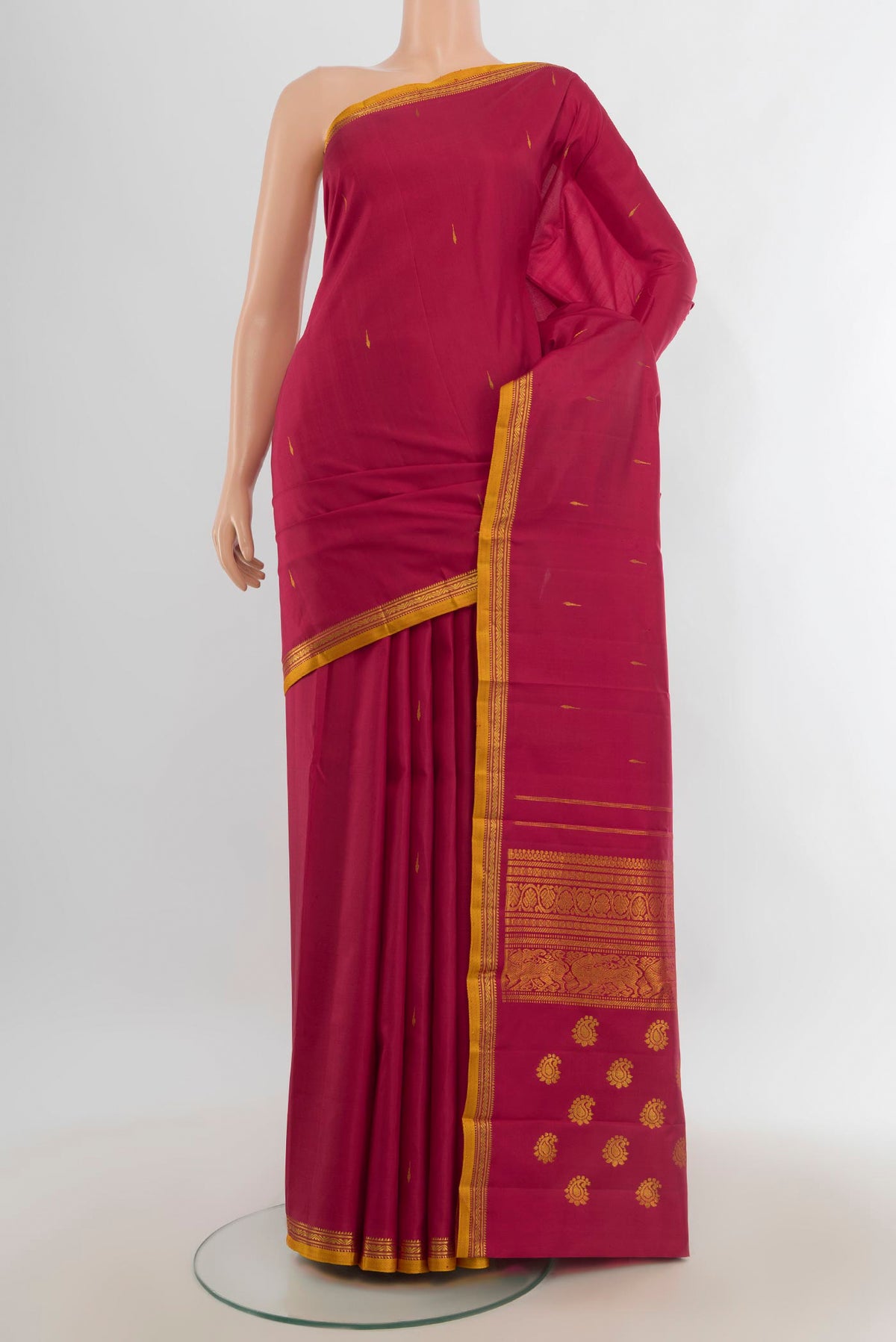 Pure Silk Pure Zari Maroon Kanjivaram Saree with Zari Butta on the body and Silk Border.  displayed on a mannequin