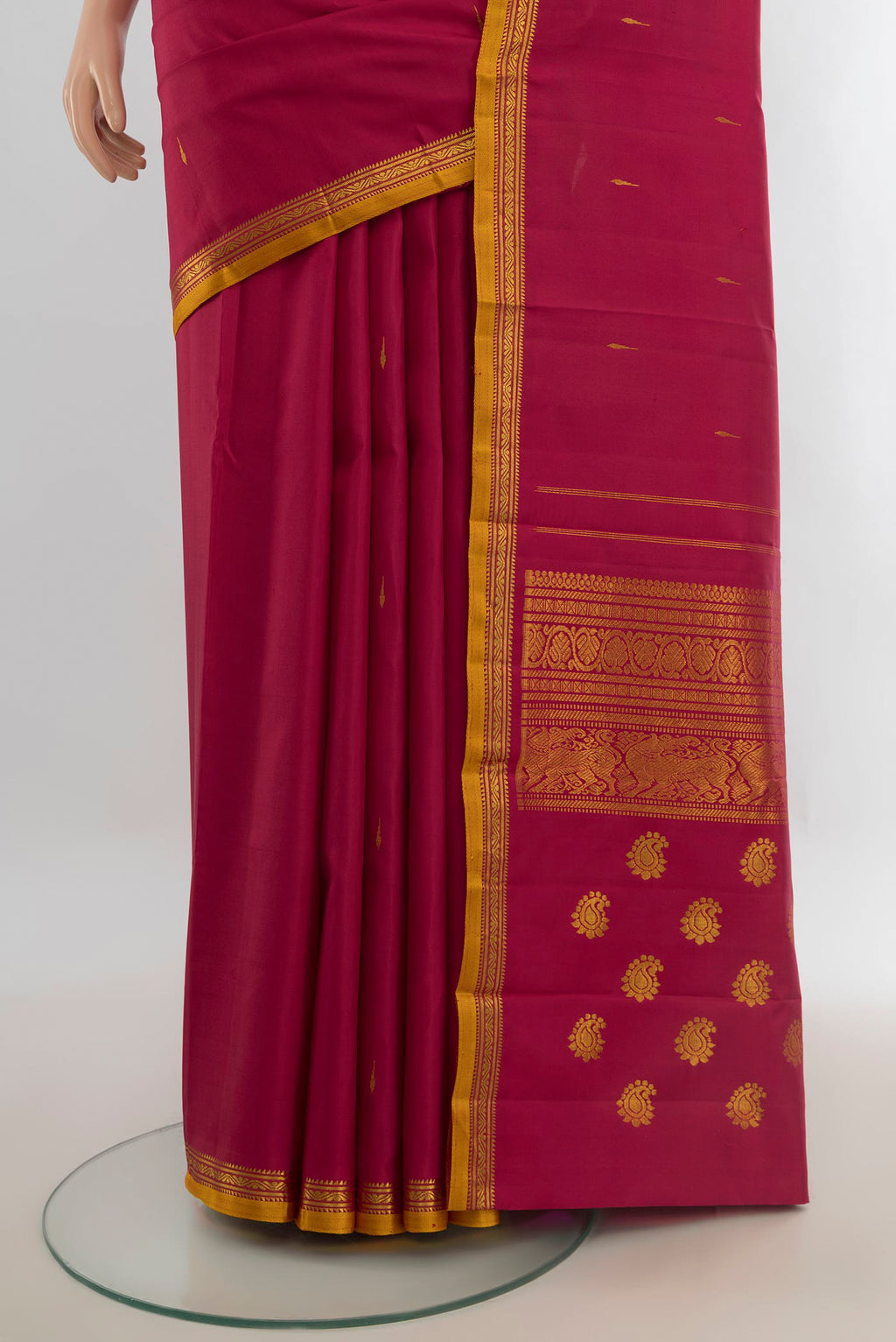 Pleats and pallu of Pure Silk Pure Zari Maroon Kanjivaram Saree with Zari Butta on the body and Silk Border. 