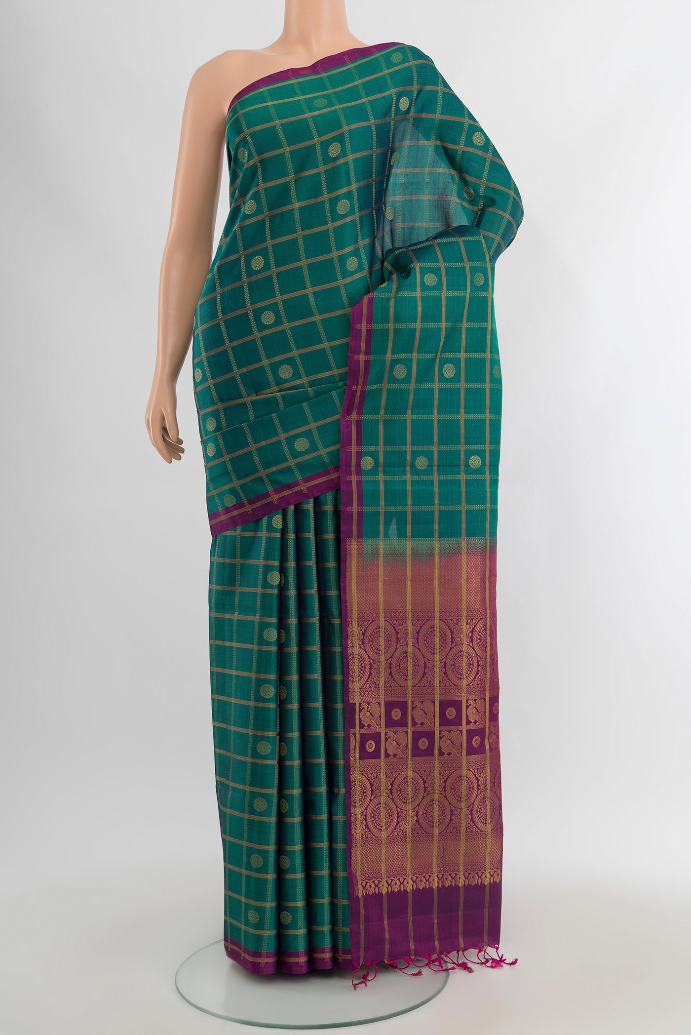 Peacock Blue Soft Silk Saree with Checked design on the body and Without Border.  displayed on a mannequin