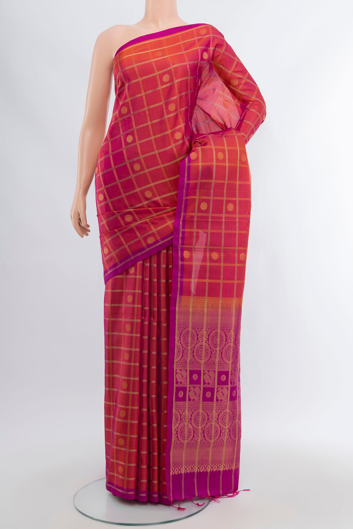Peach Soft Silk Saree with Zari Butta on the body and Silk Border.  displayed on a mannequin